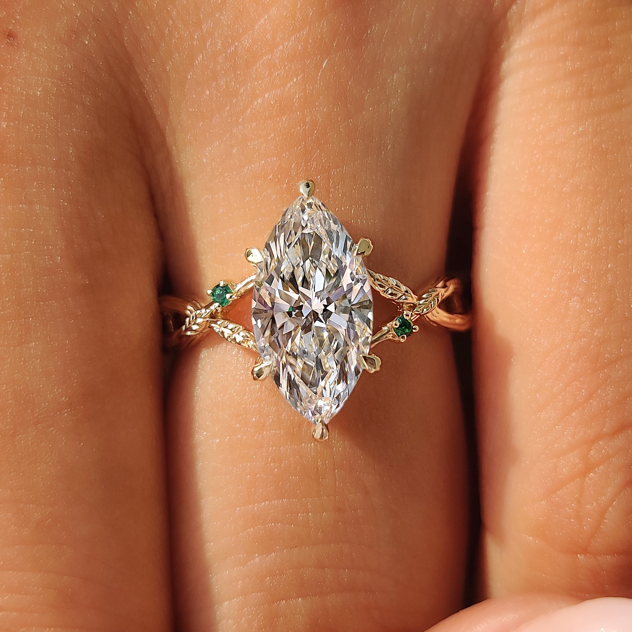 Marquise cut center diamond in a yellow gold ring.
