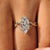 Marquise cut center diamond in a yellow gold ring.
