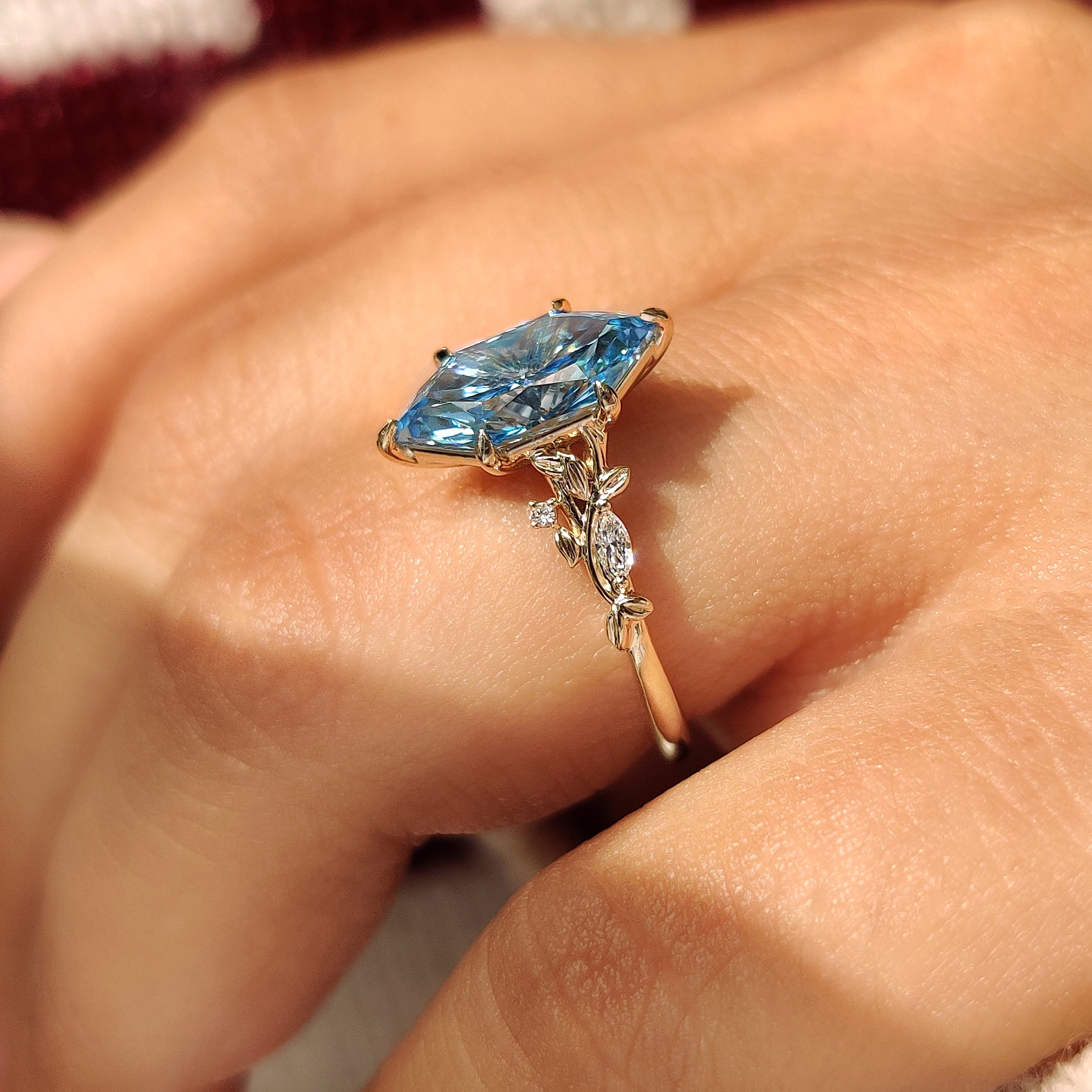 Nature inspired ring with blue center diamond and side stones
