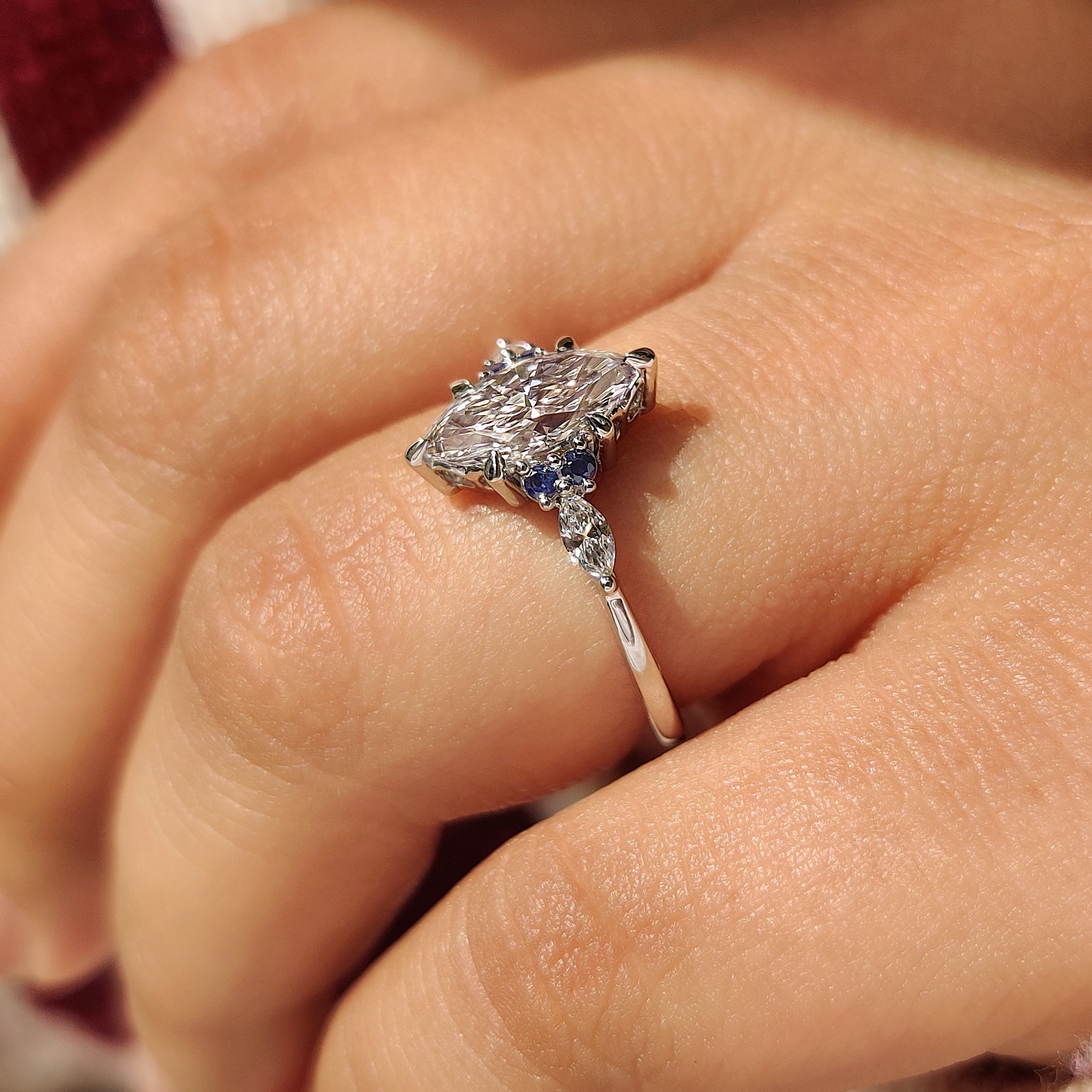Lab grown diamond ring with marquise and sapphire stones
