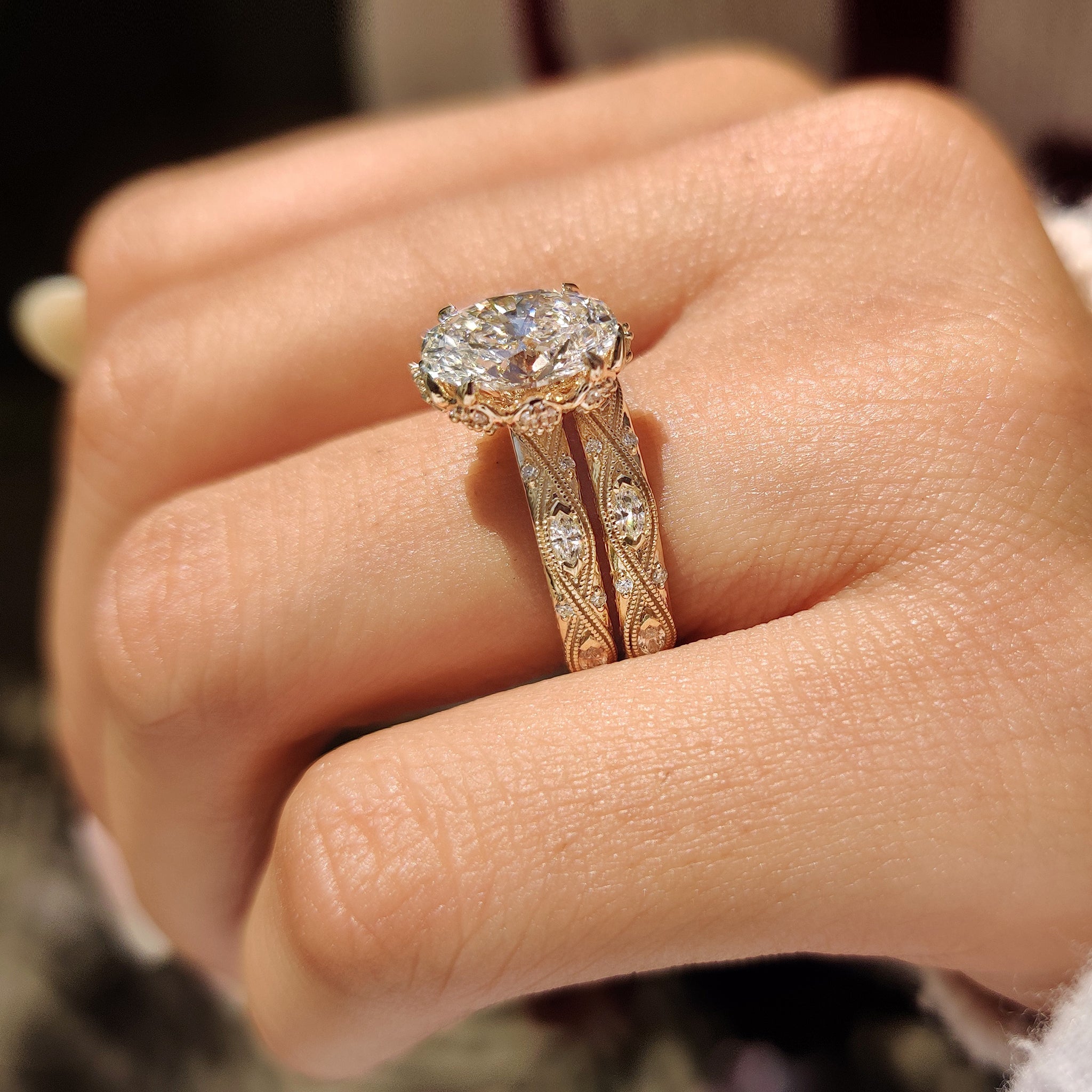Oval cut engagement ring with filigree shank and milgrain details.
