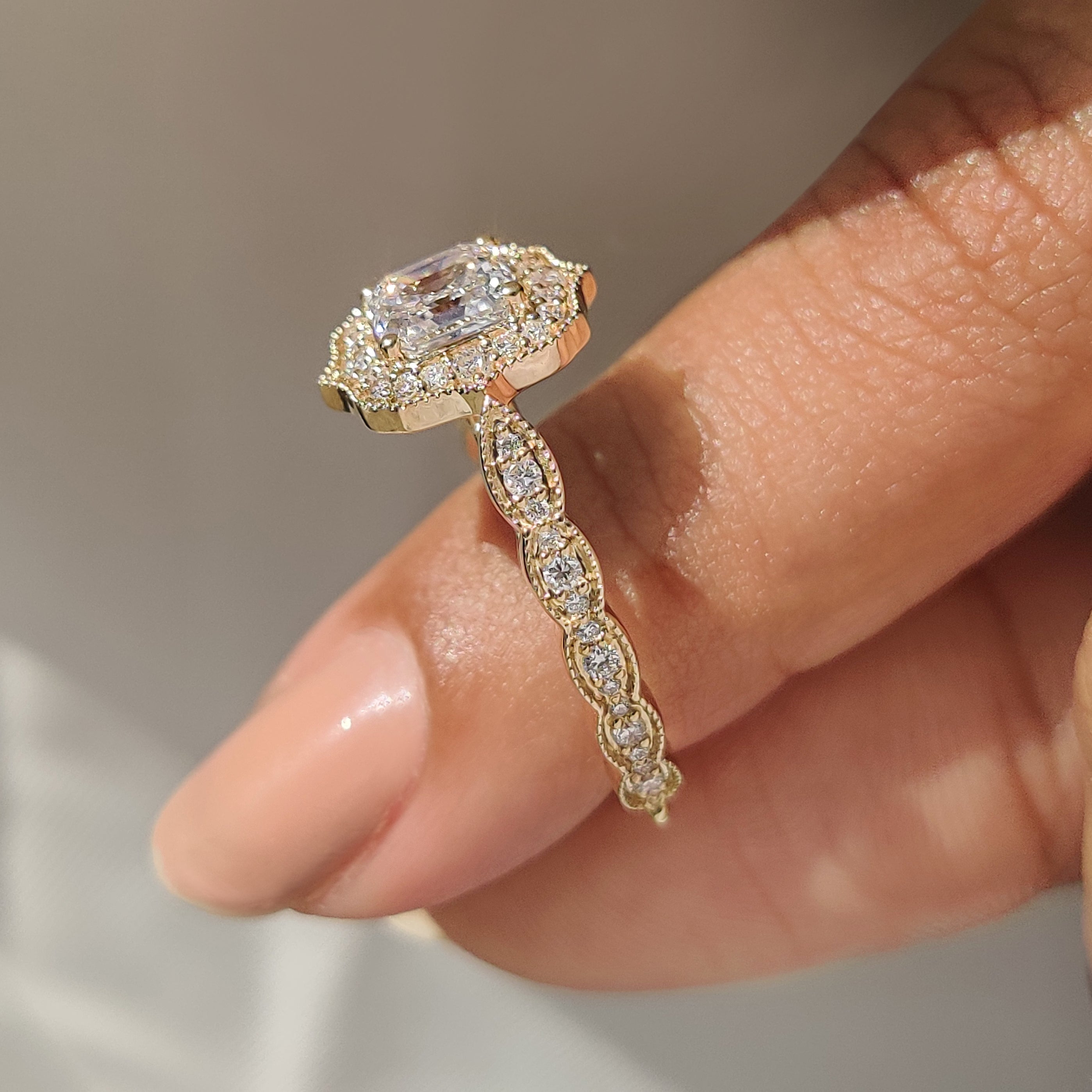 Asscher cut diamond ring with four prong cathedral setting.
