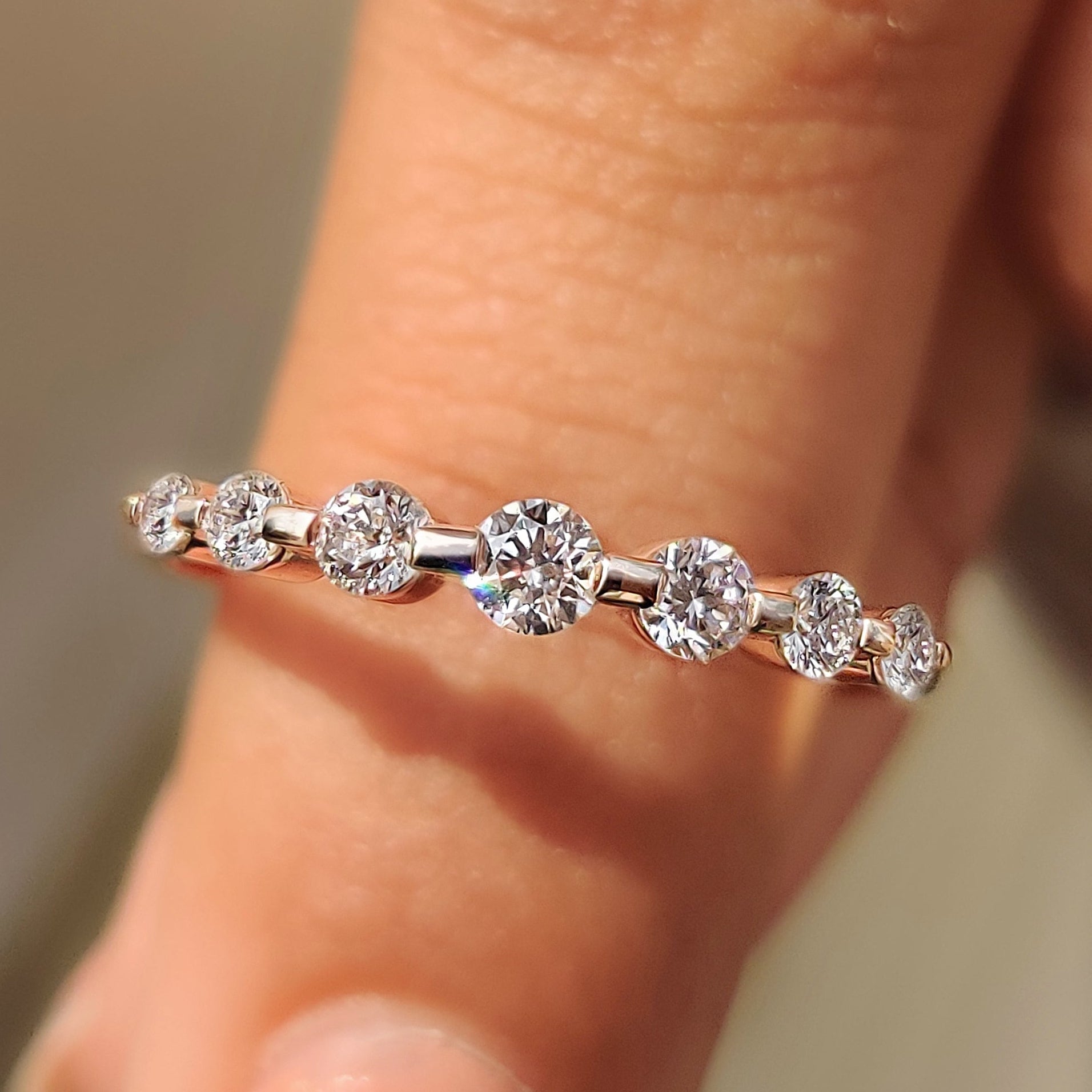 Round diamond band with seven stone shared prong setting.
