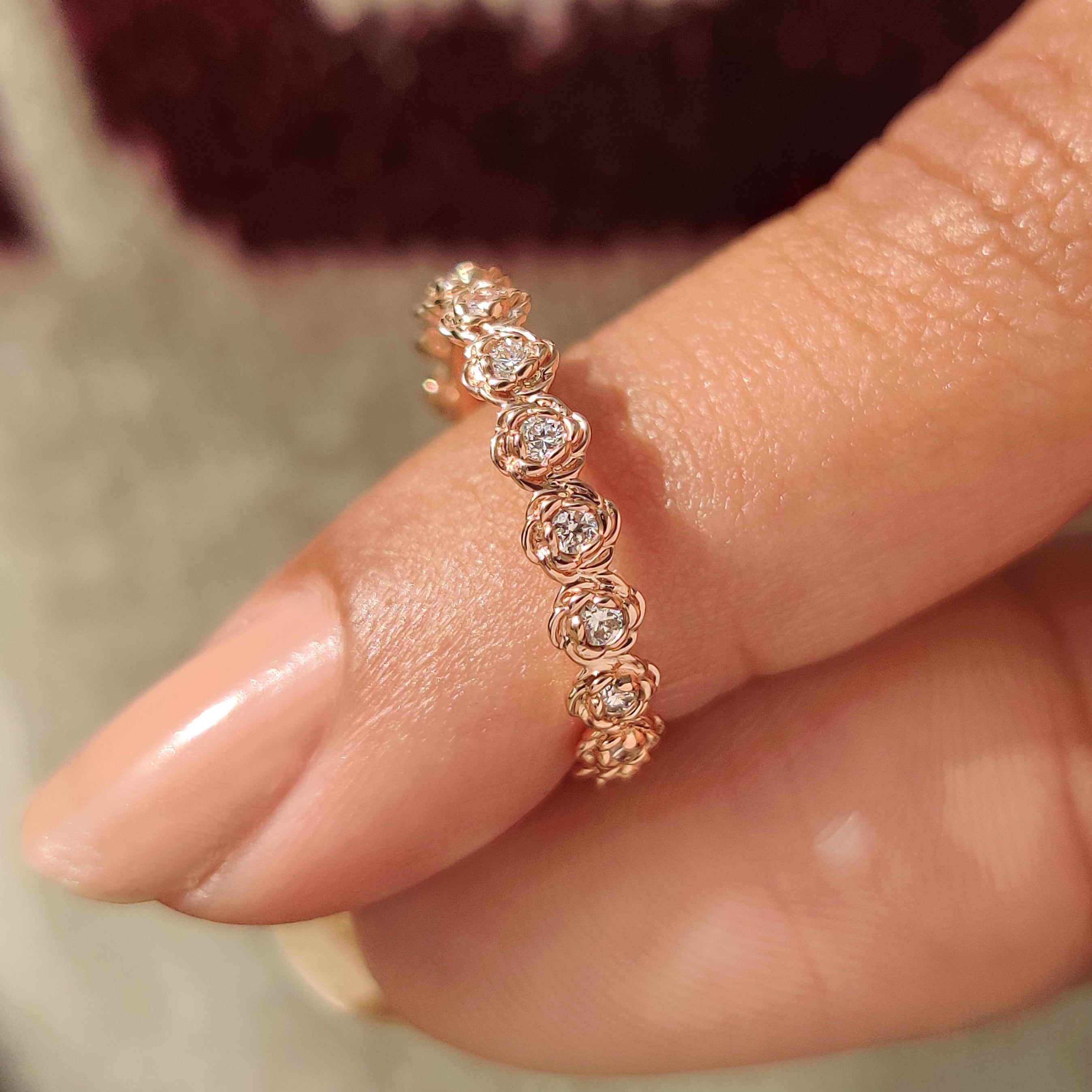 Floral wedding band with round diamond eternity style setting.
