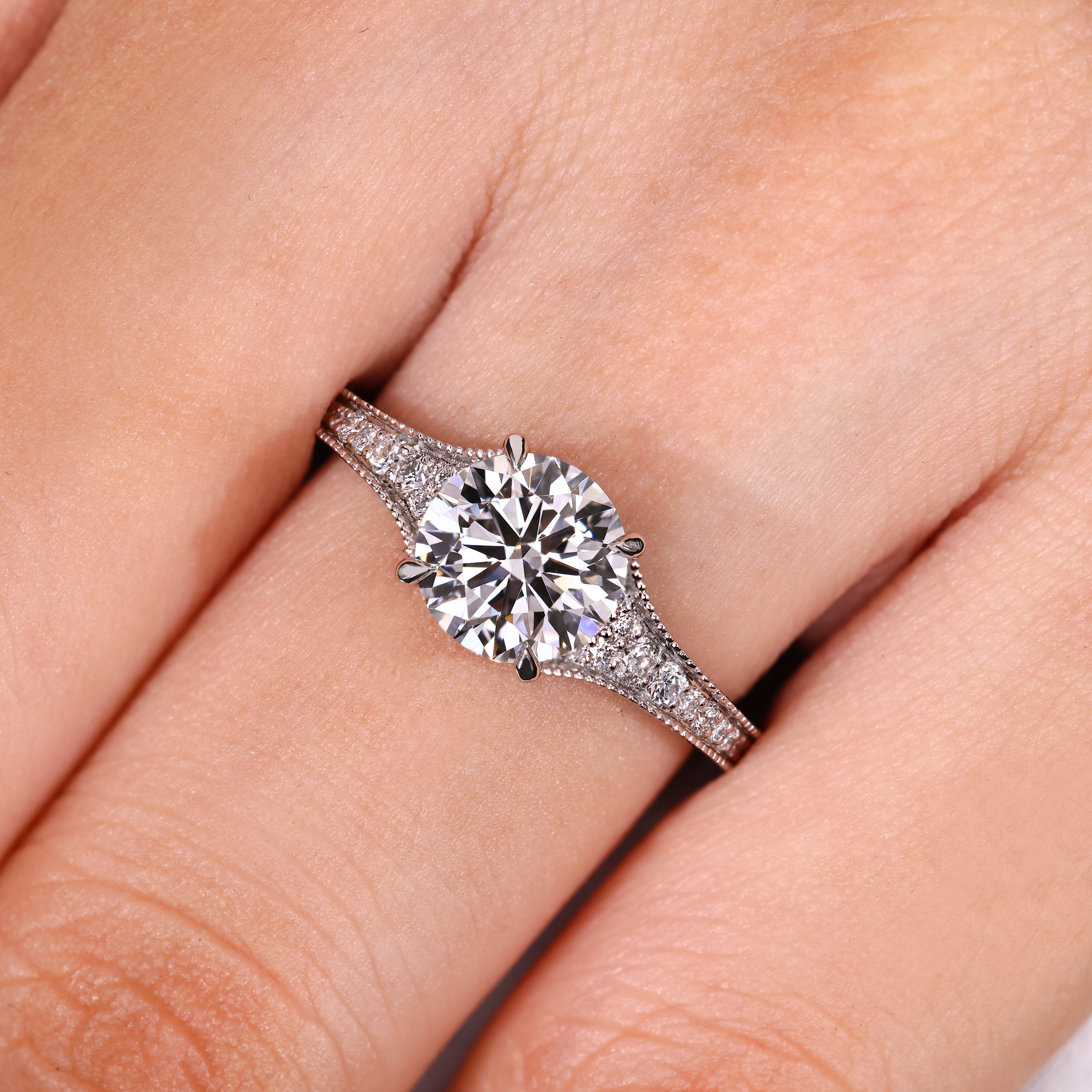 Round diamond engagement ring with four claw prong setting
