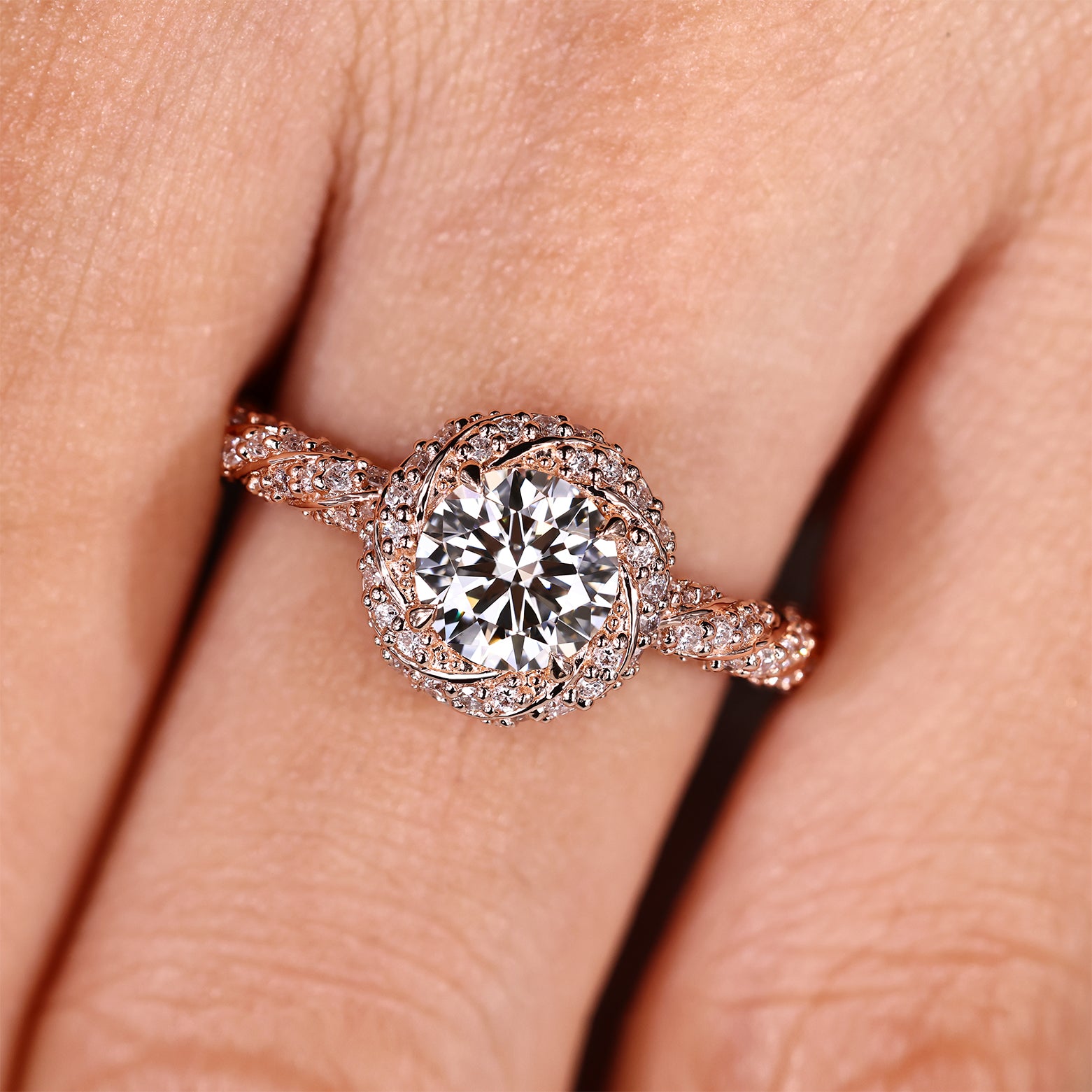 Round diamond ring with twisted design and pave accents
