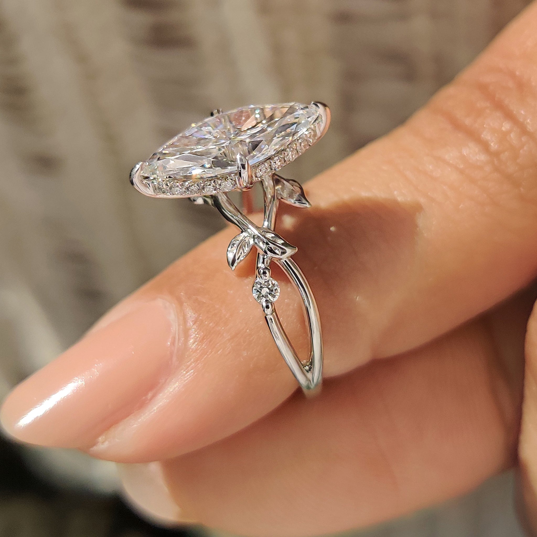 Marquise cut diamond ring with round side stone setting.
