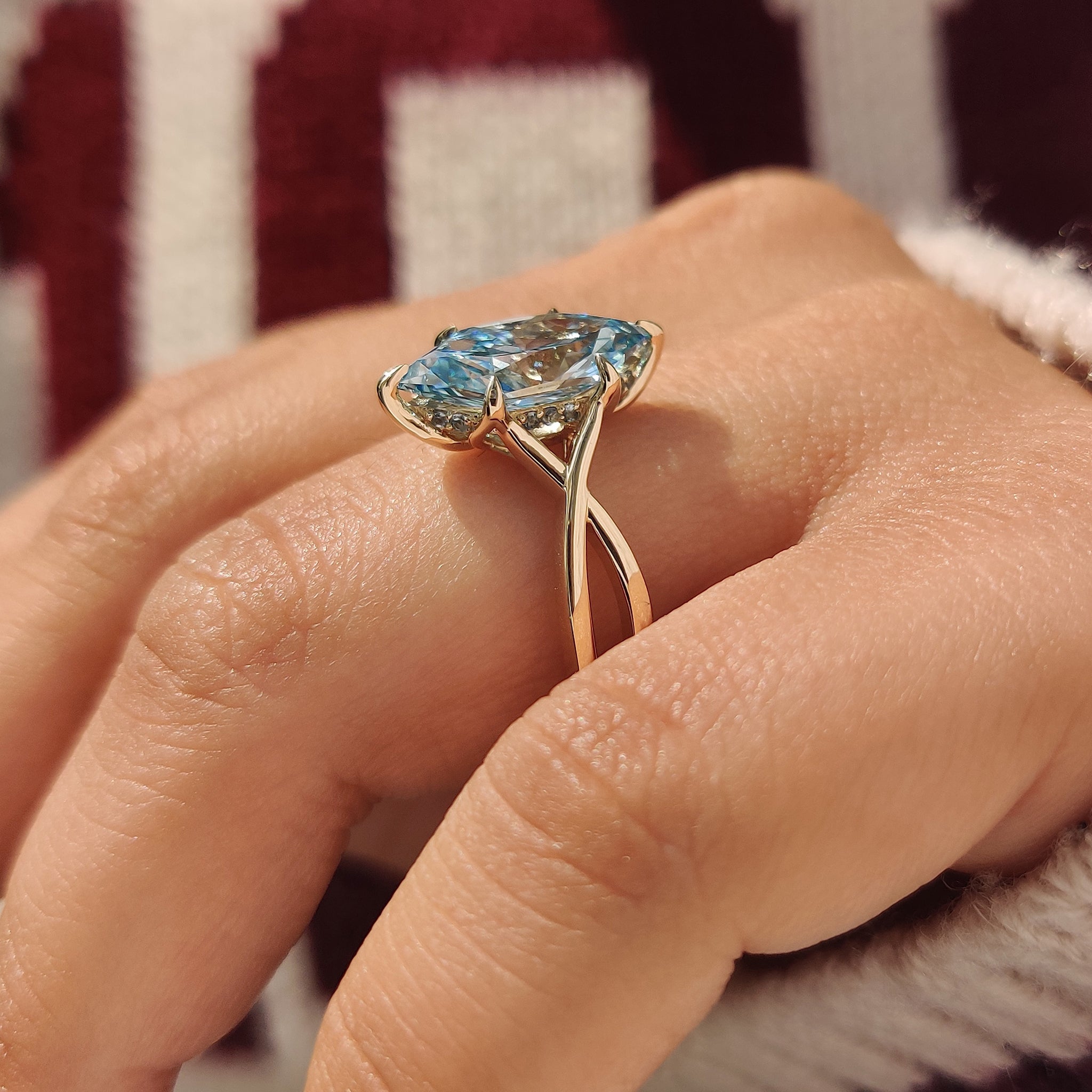 Blue aquamarine engagement ring with six claw prong setting
