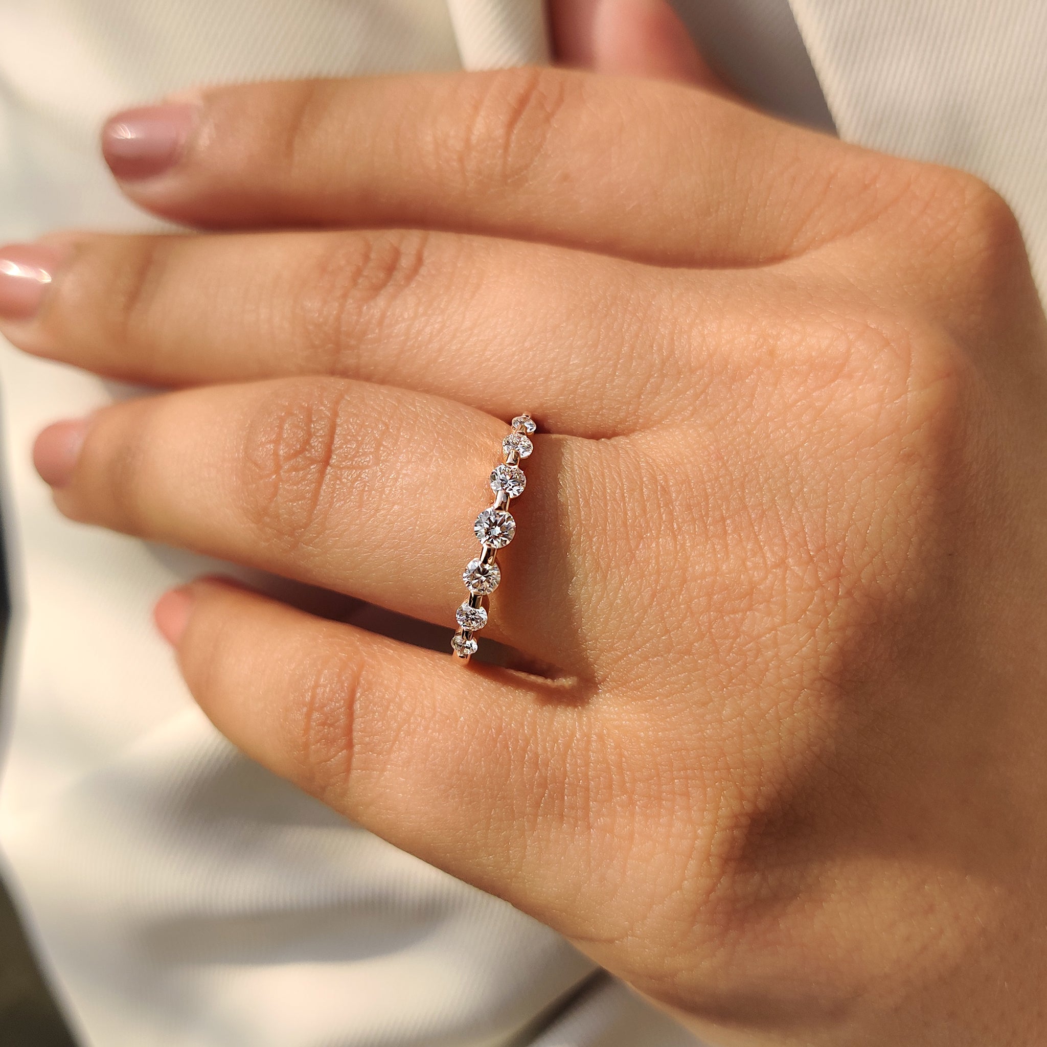 Handmade round diamond band with shared prong design.
