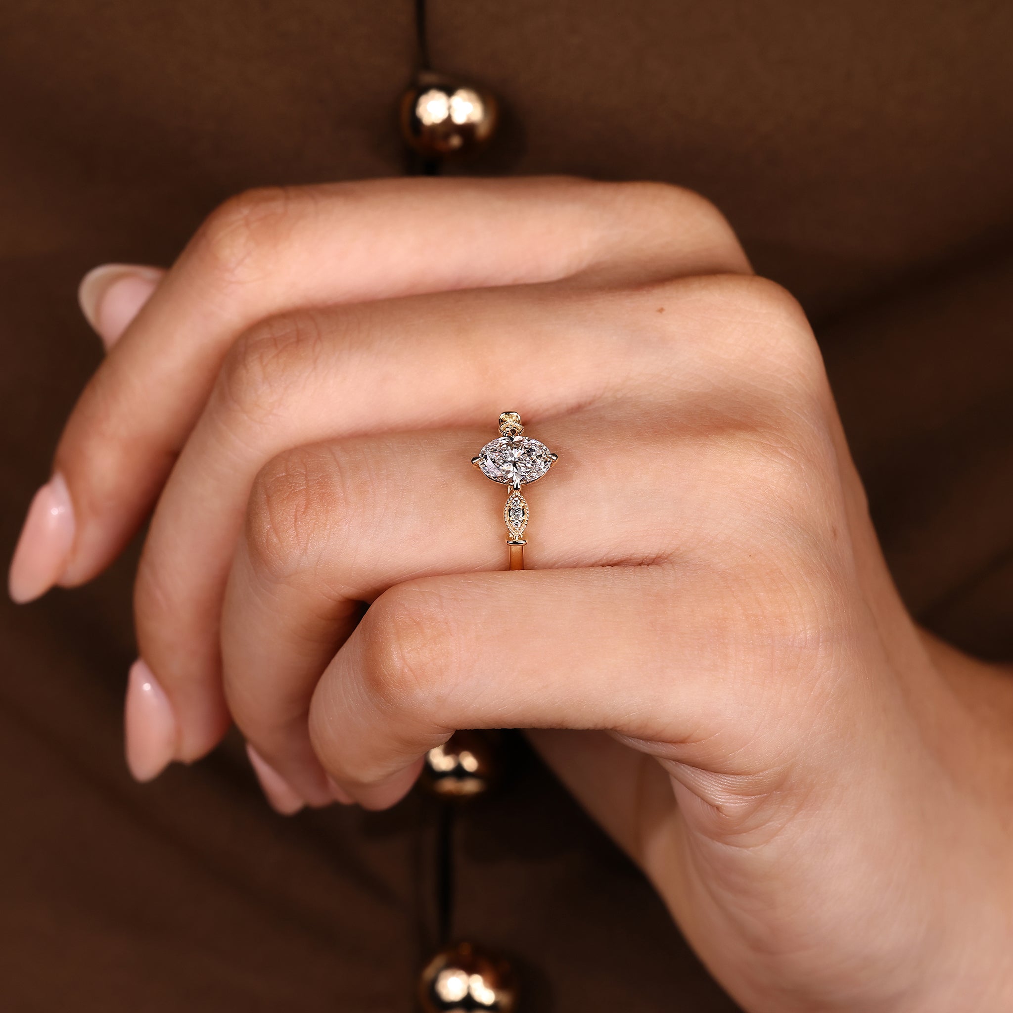 Handmade oval diamond ring with round side stone accents
