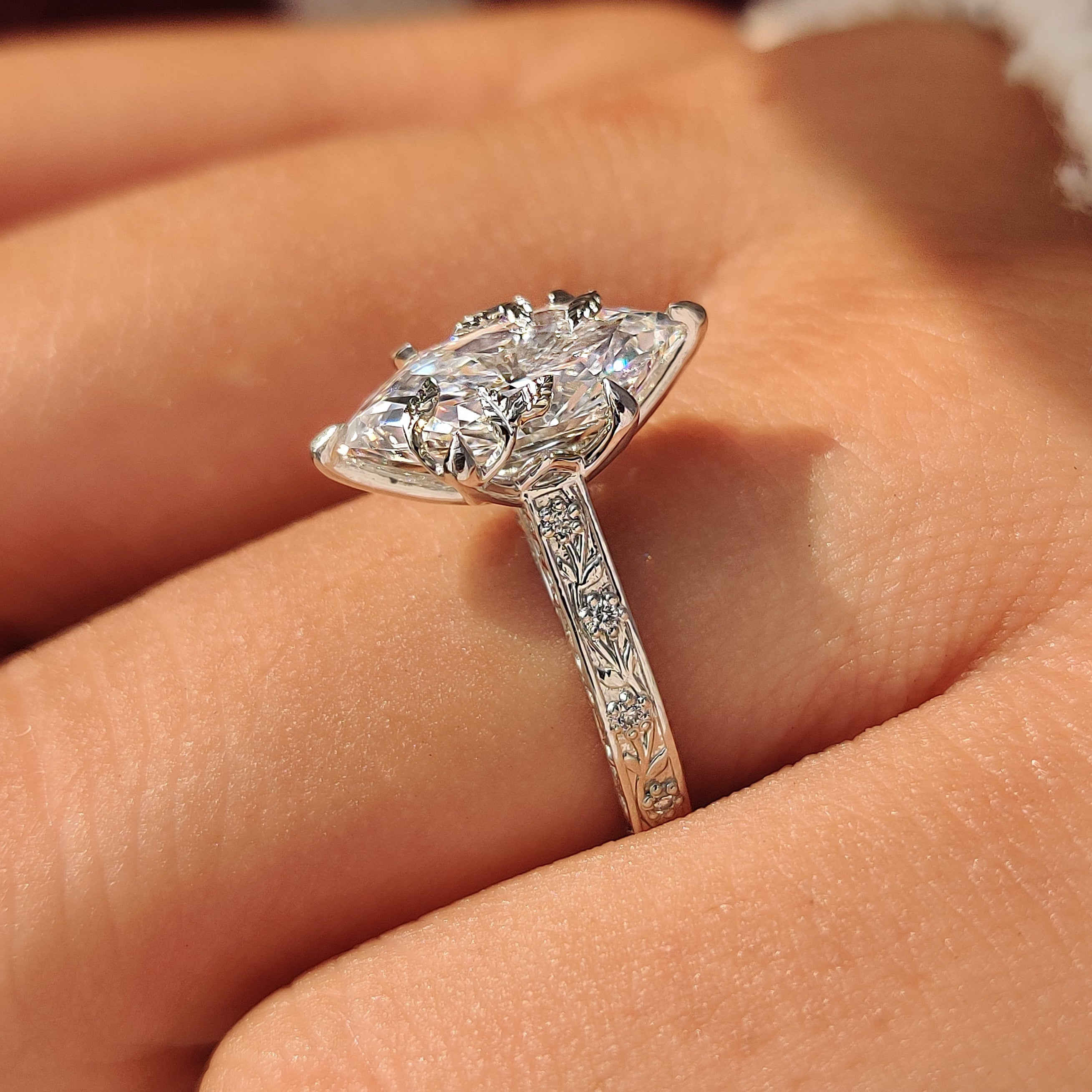 Dutch marquise ring with round diamond accents.
