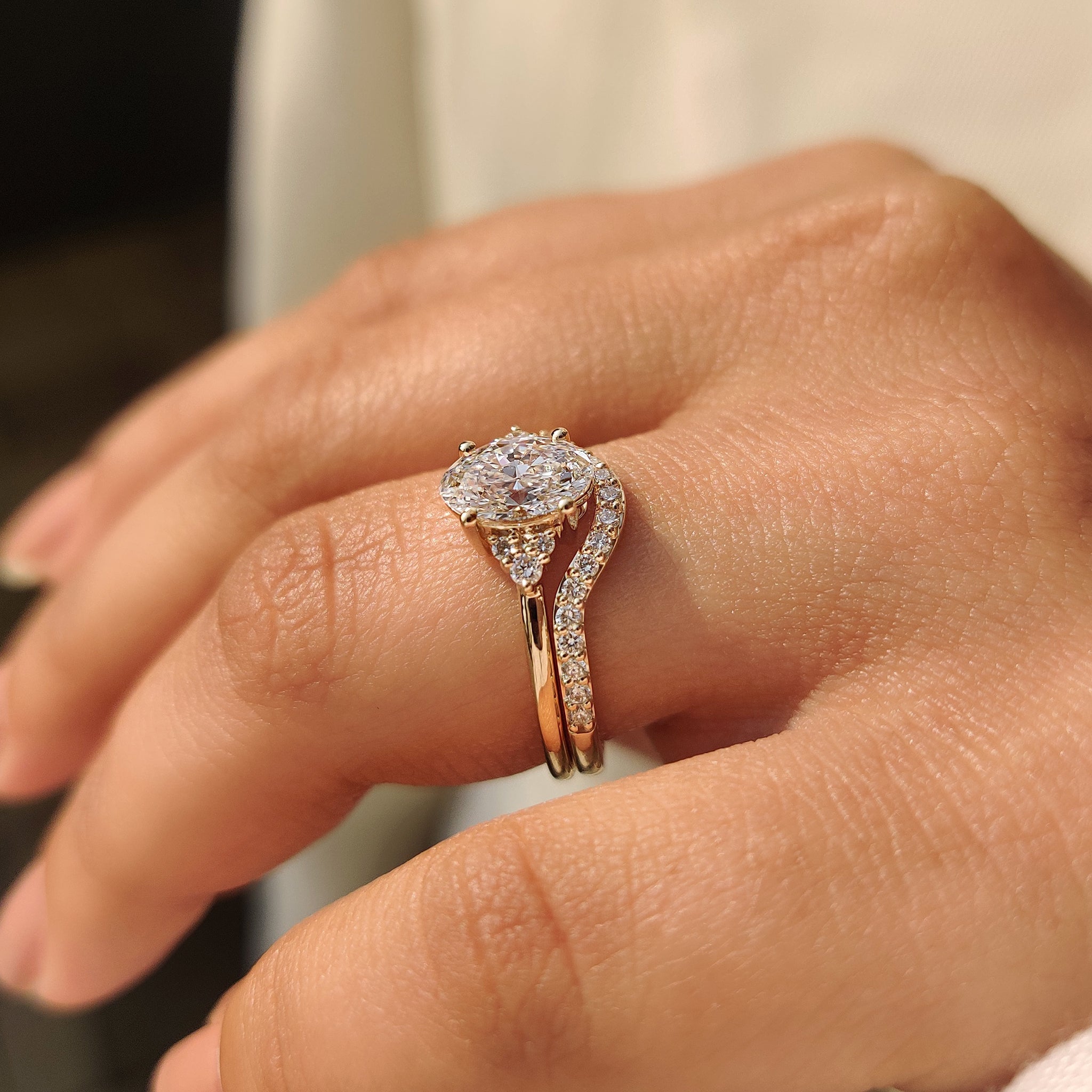 Handmade oval diamond ring set with round side stones.
