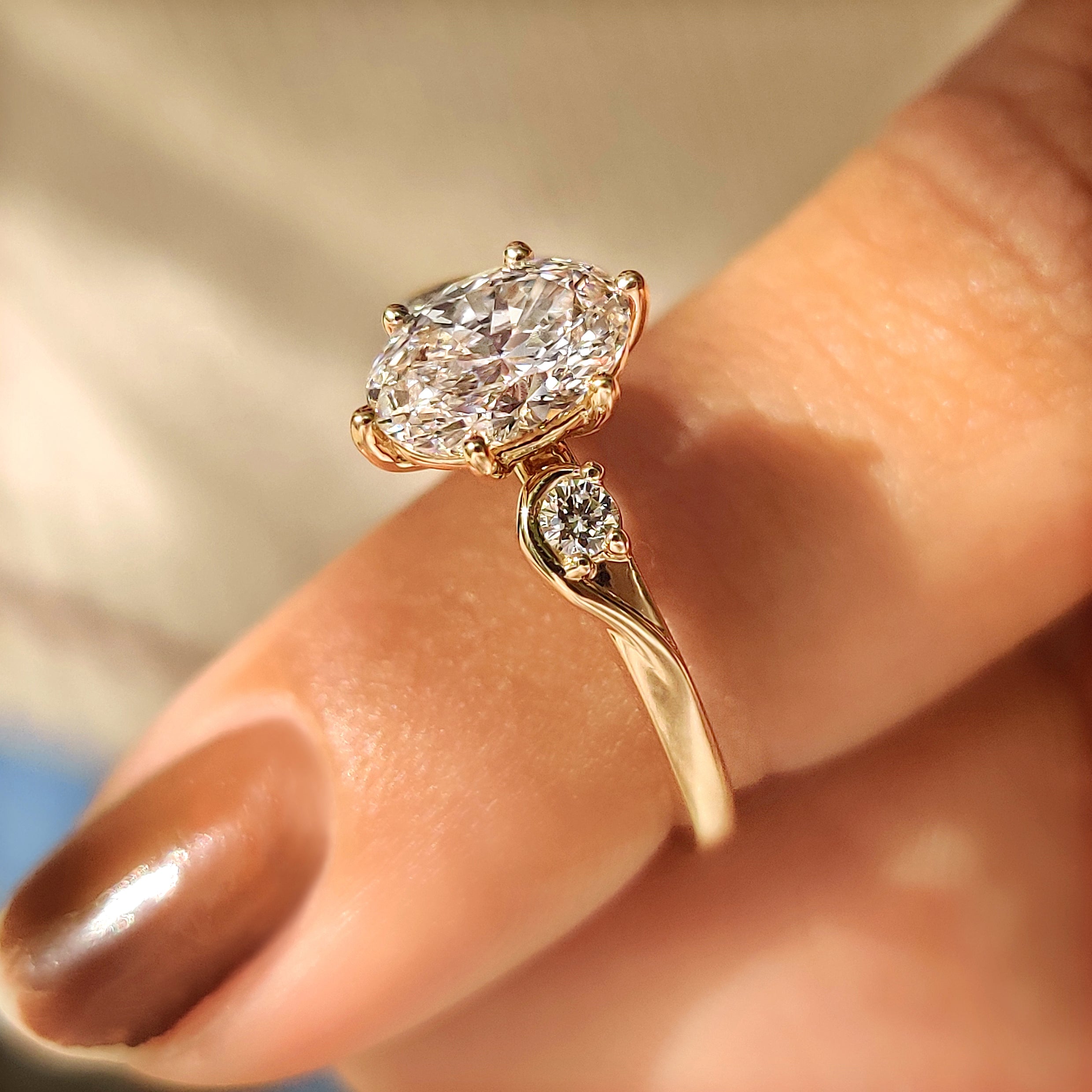 Three stone oval engagement ring with basket setting design
