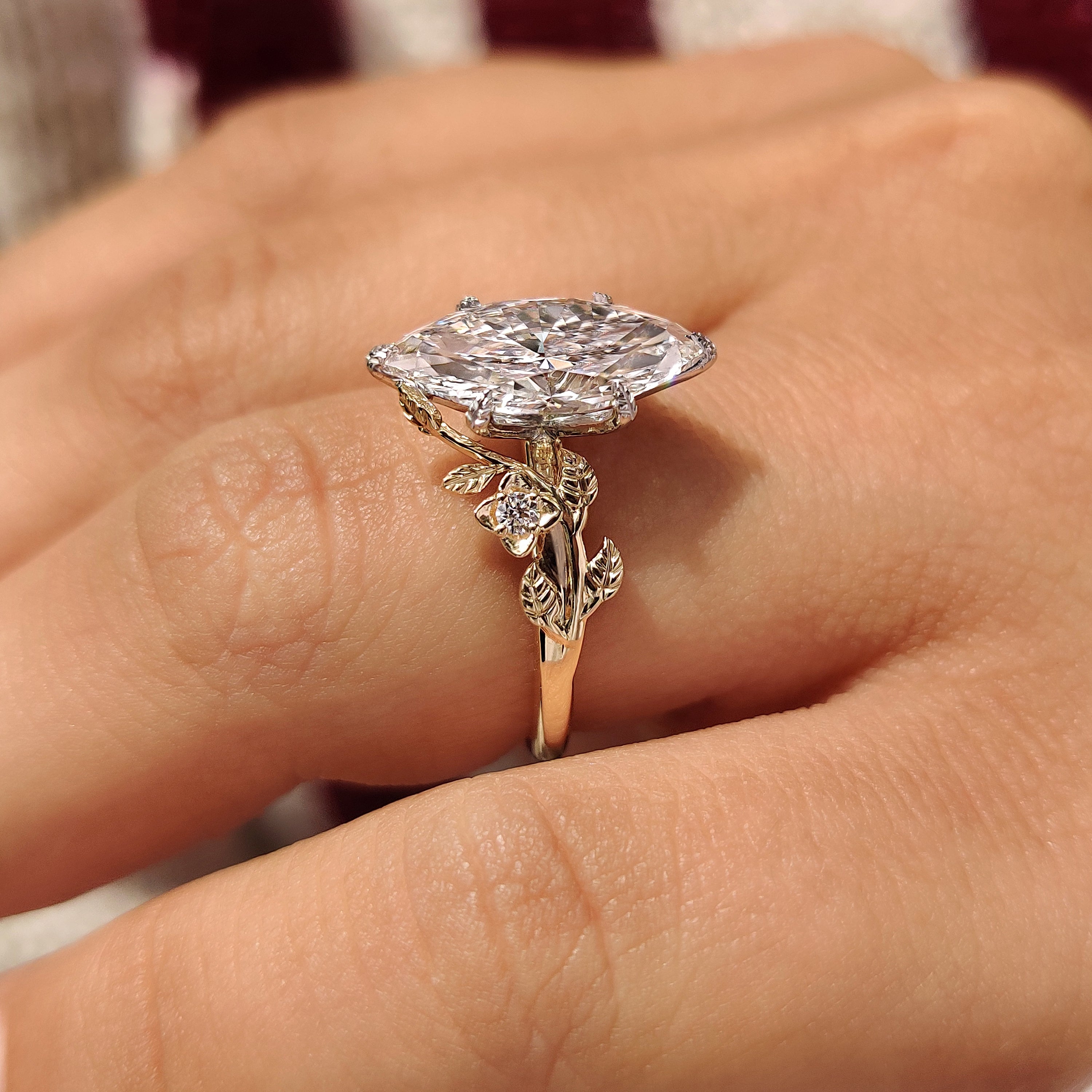 Round side stones beside marquise center diamond
