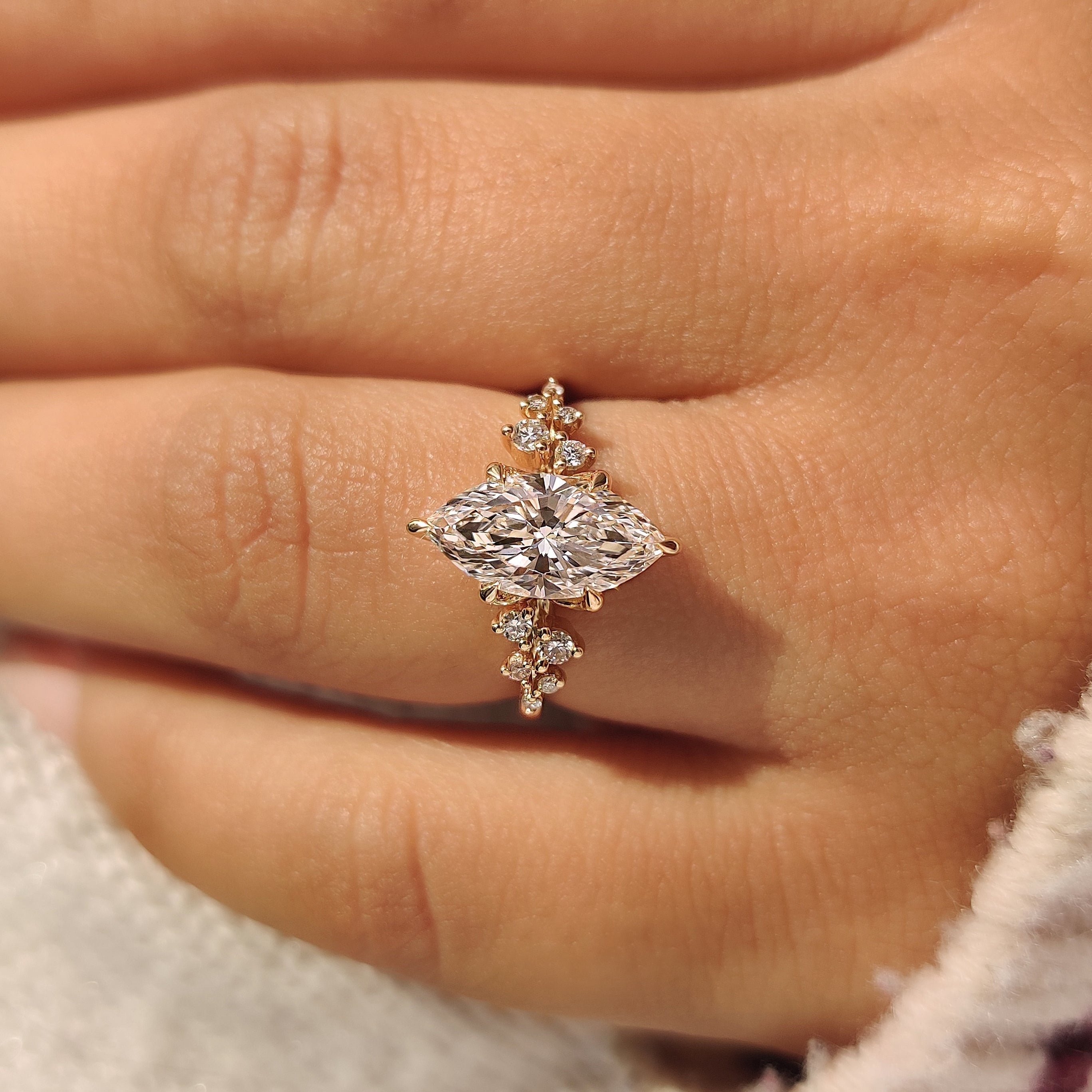 Marquise Engagement Ring with six claw prong setting and round side stones
