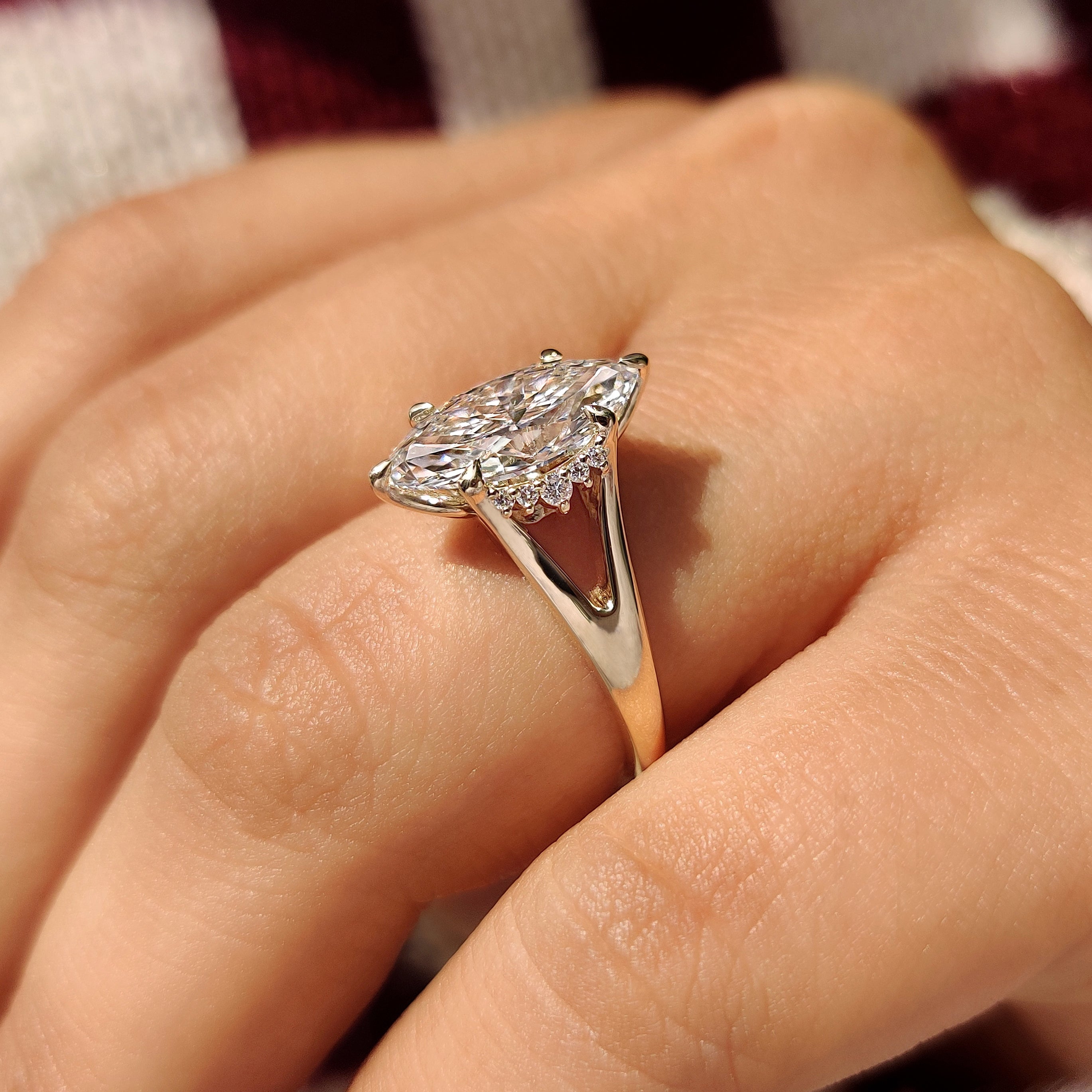 Split shank marquise diamond ring with round side stones
