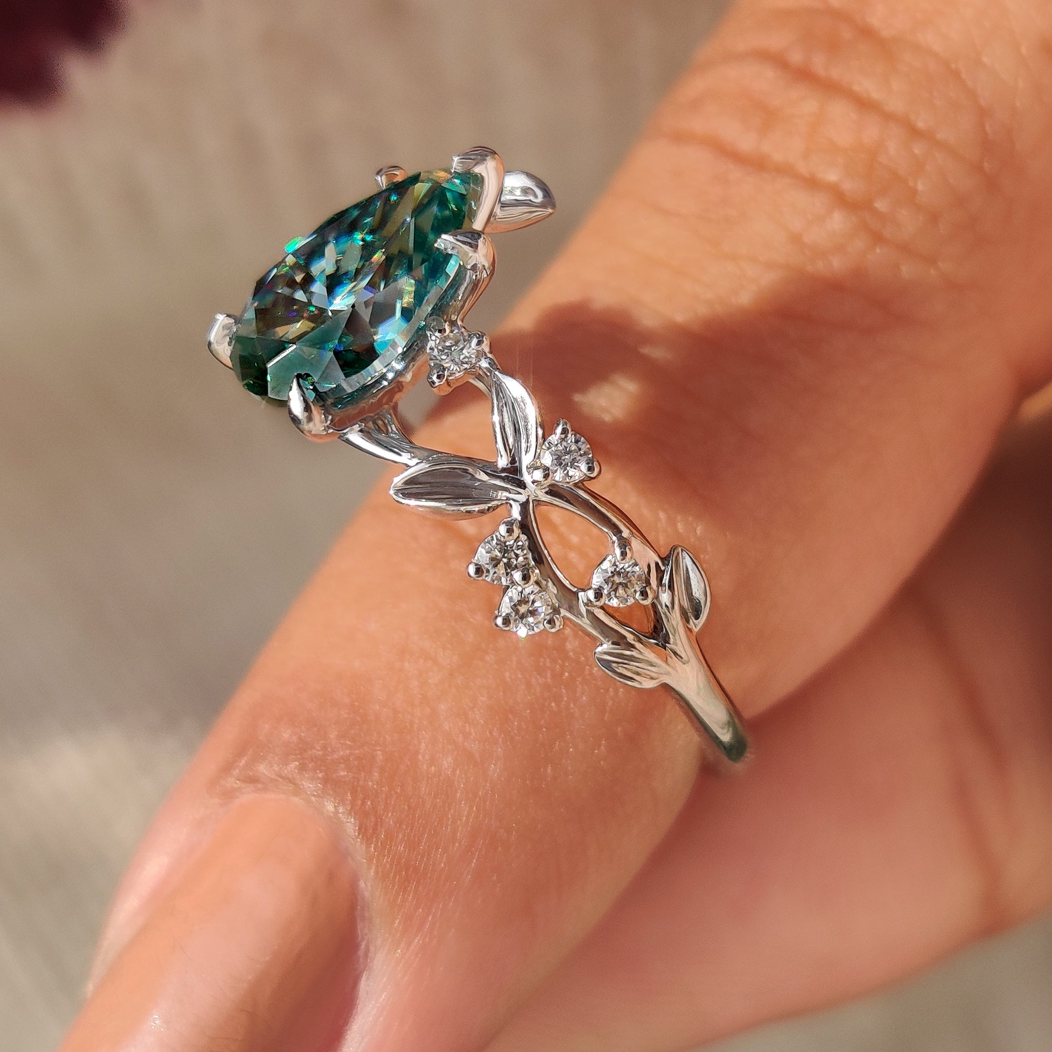 Cyan blue pear moissanite ring leaves and petals style
