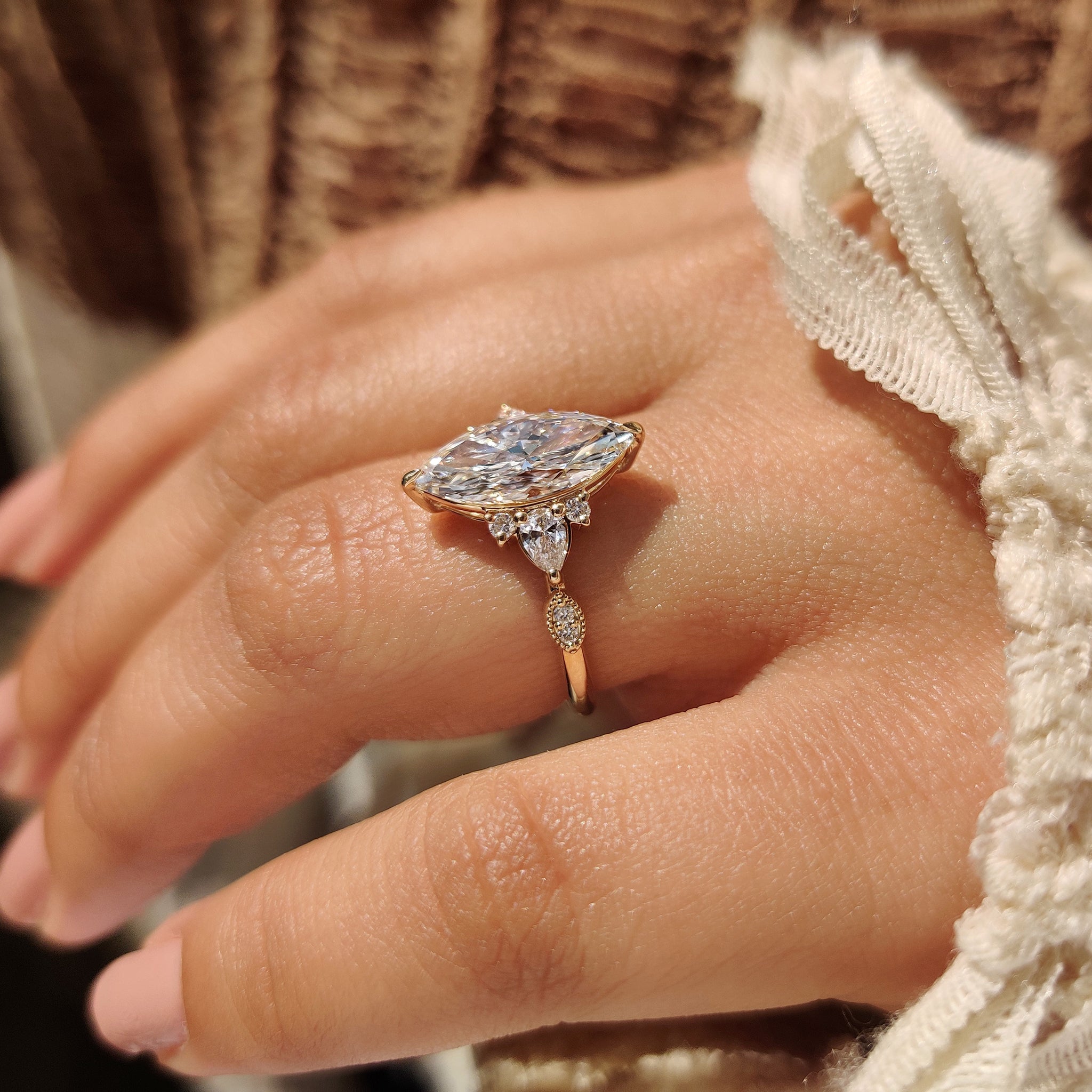 Lab grown marquise ring with pear and round accents.
