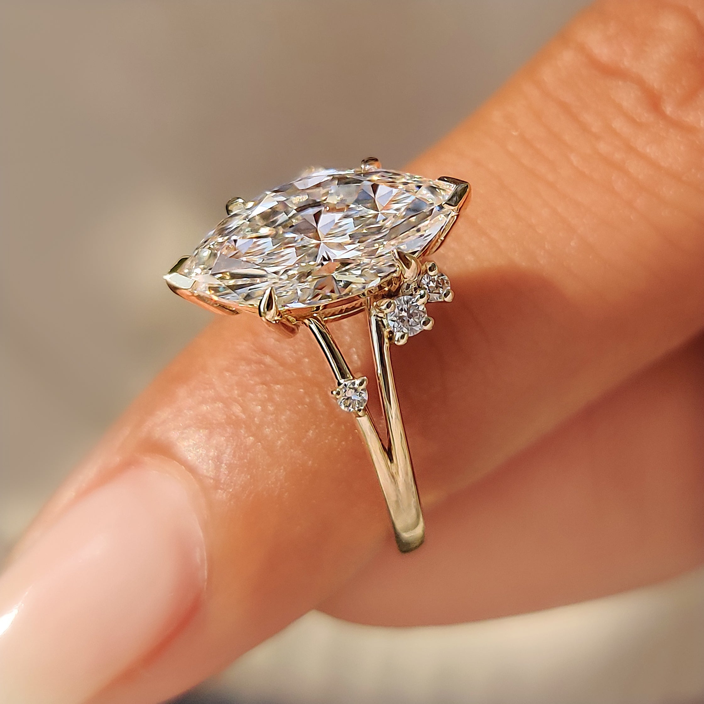 Open gallery basket below a marquise center diamond.
