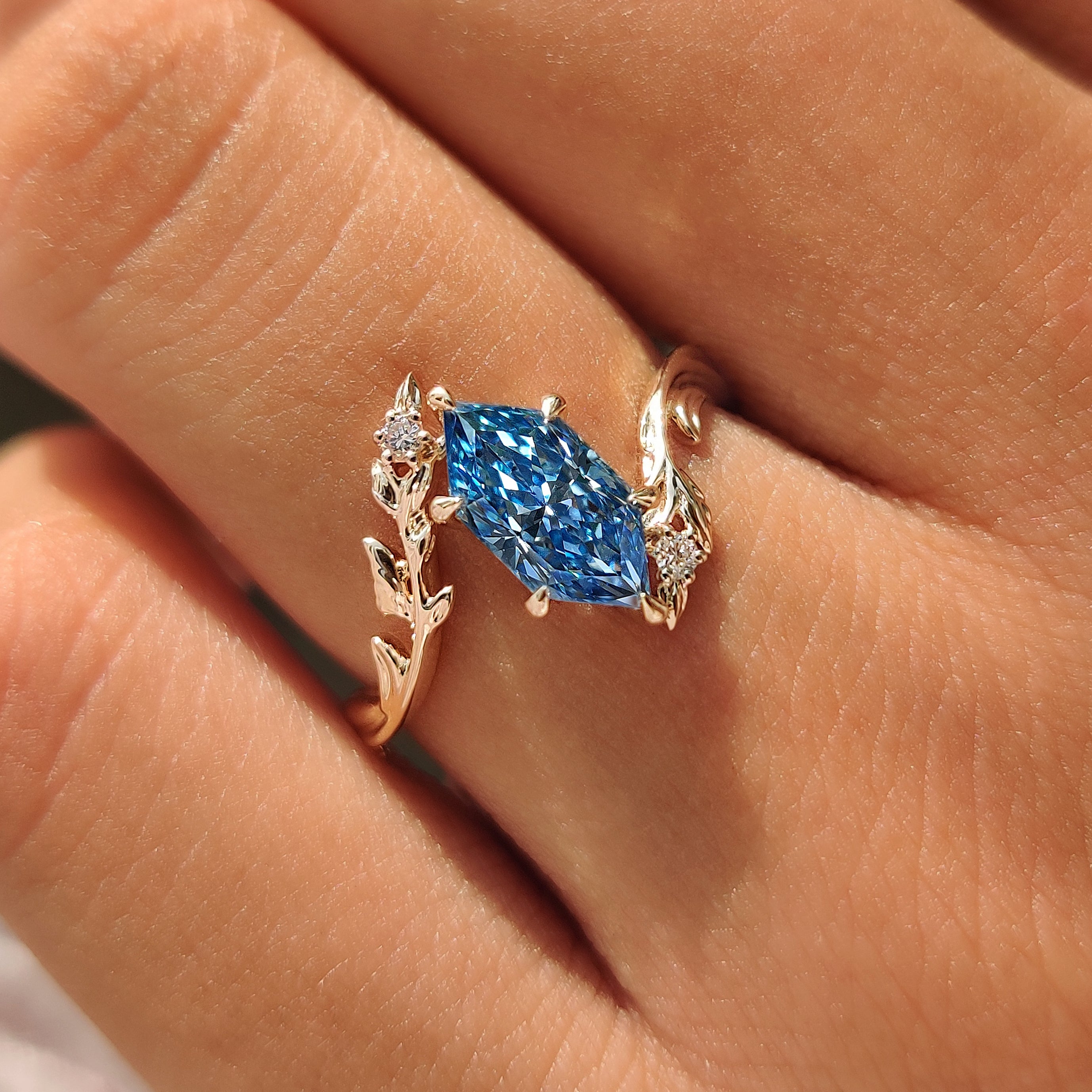 Nature inspired ring with round diamond leaf accents.

