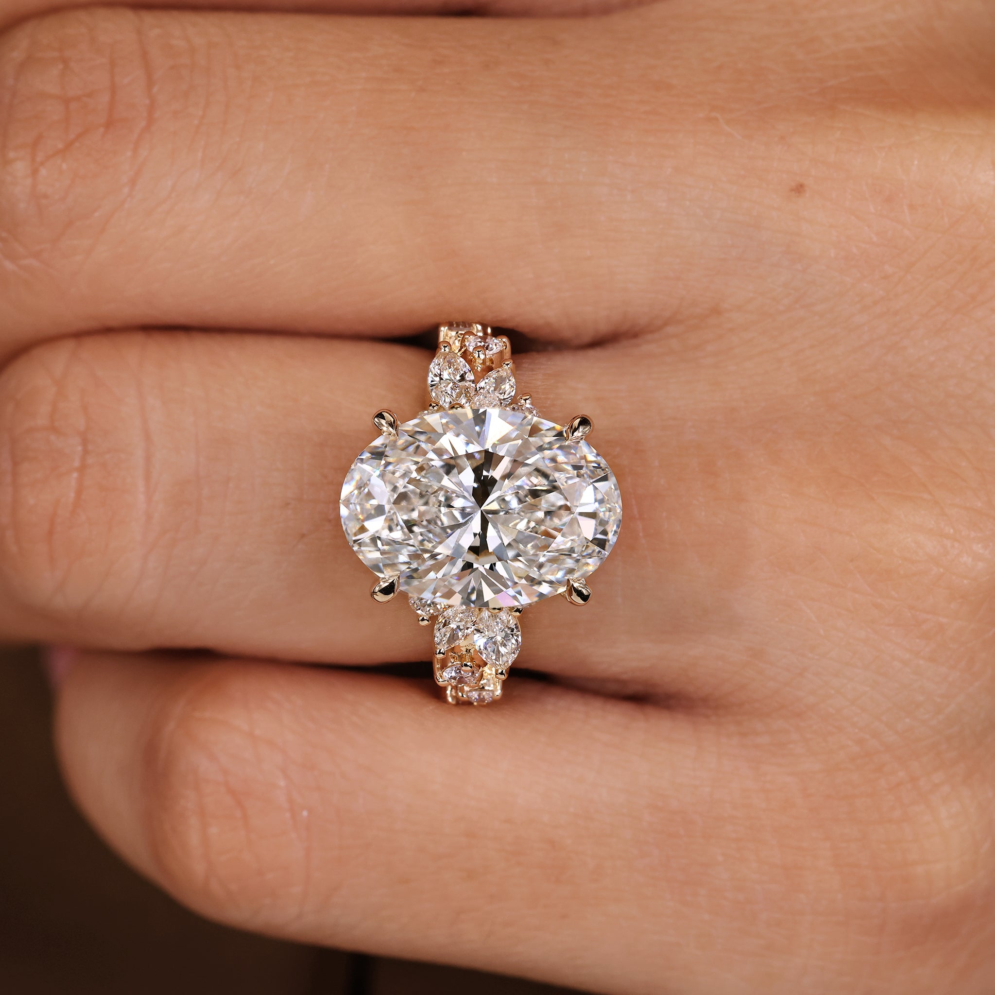 Oval cut diamond ring with handmade cluster setting of marquise and round diamonds.
