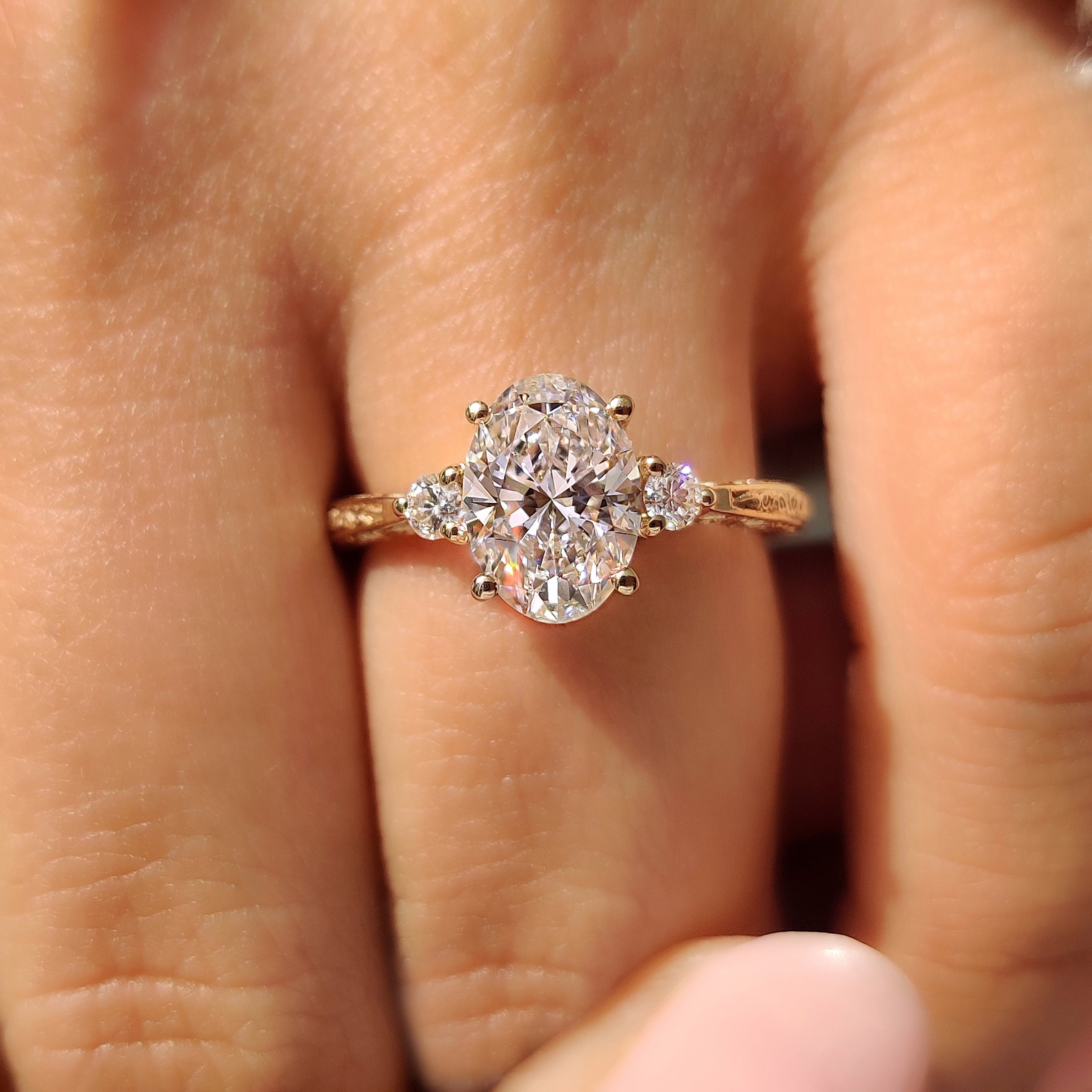 Three stone oval diamond ring with basket setting.
