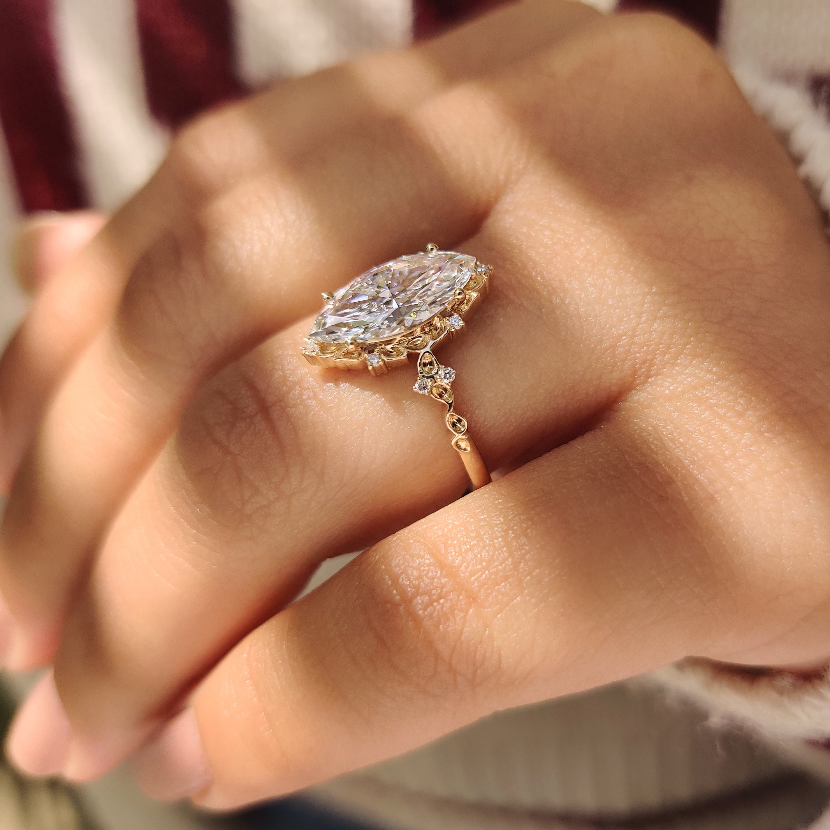 Lab grown marquise diamond ring with cluster and prongs.
