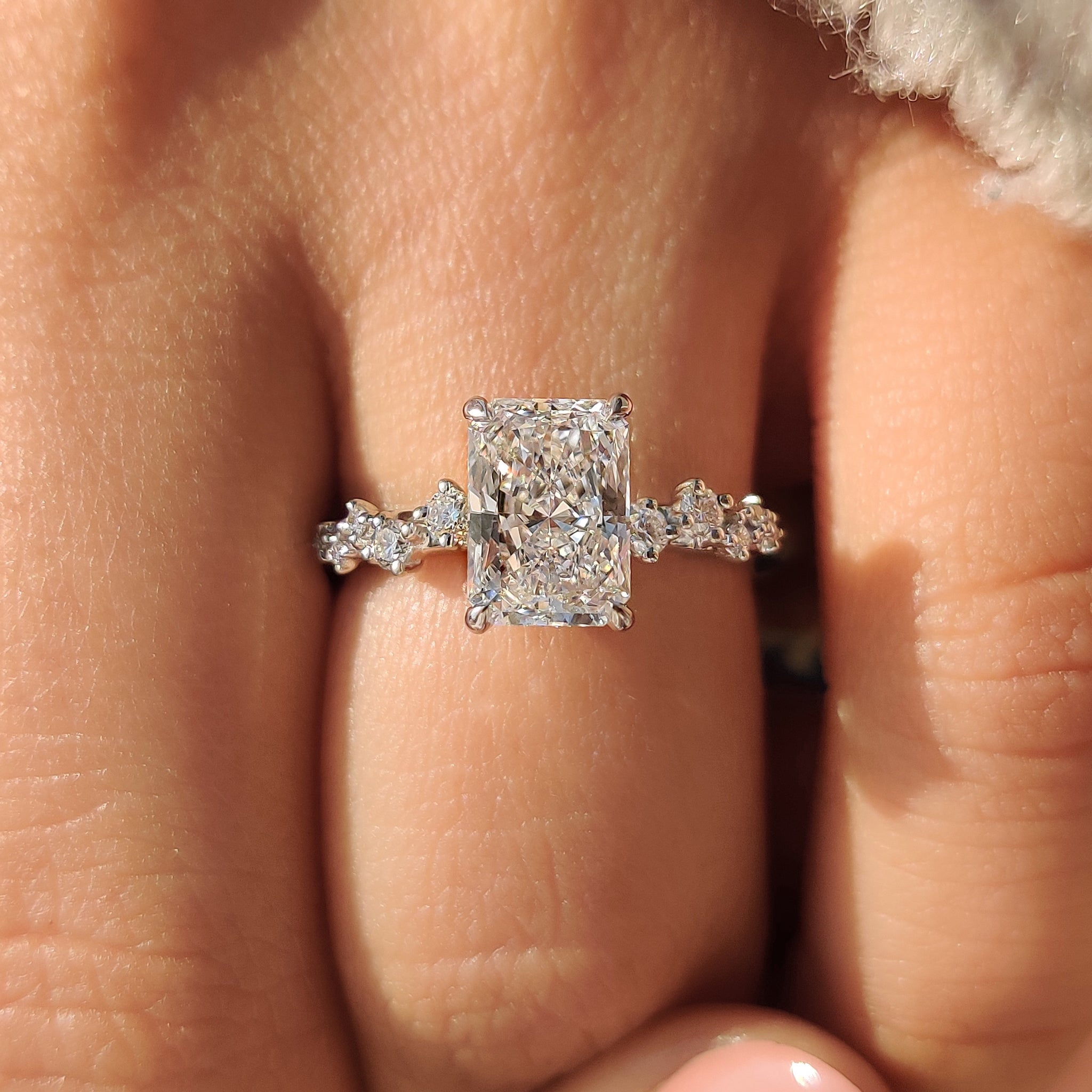 Cluster setting radiant cut diamond ring with extra sparkle.
