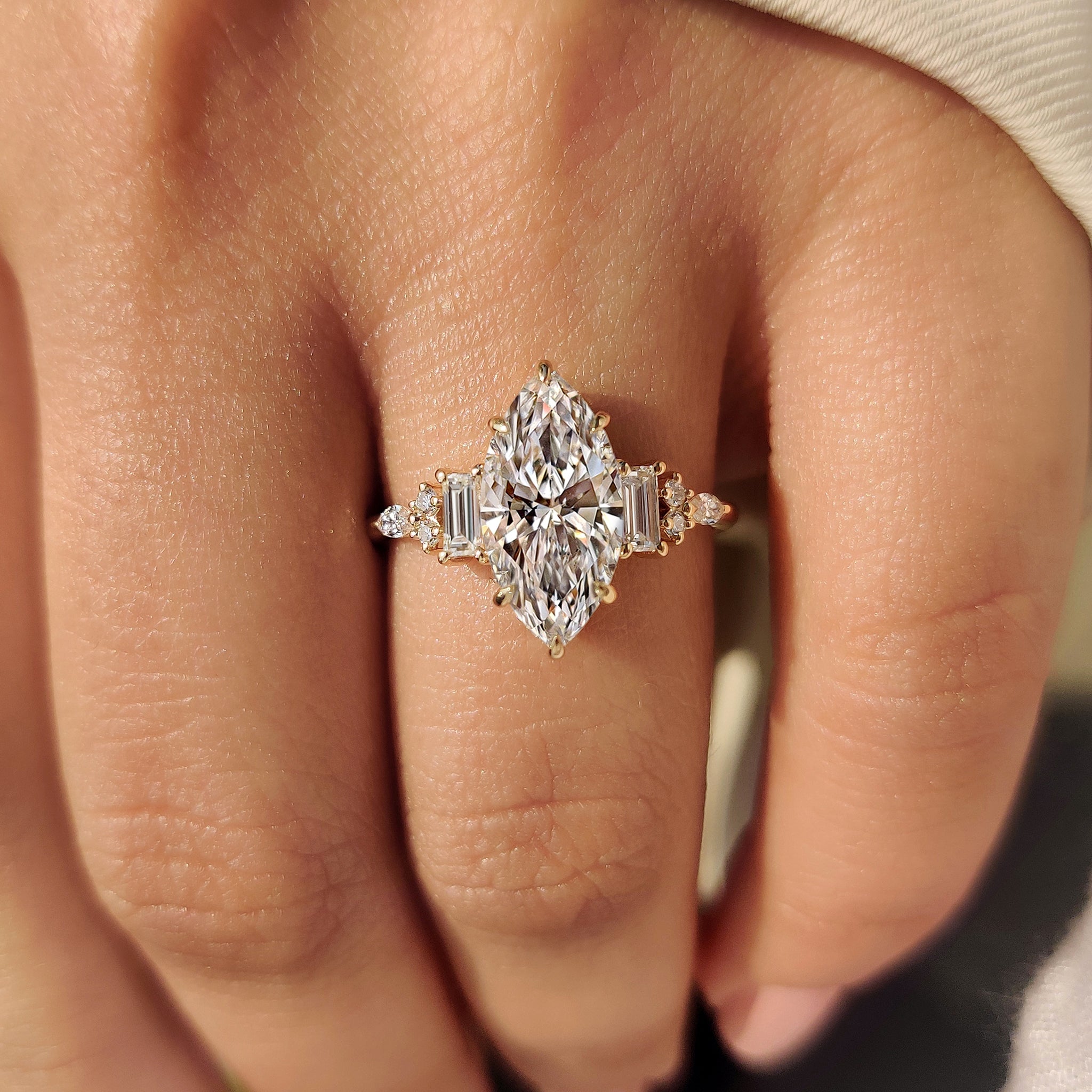 Marquise cut diamond ring with baguette side stones.
