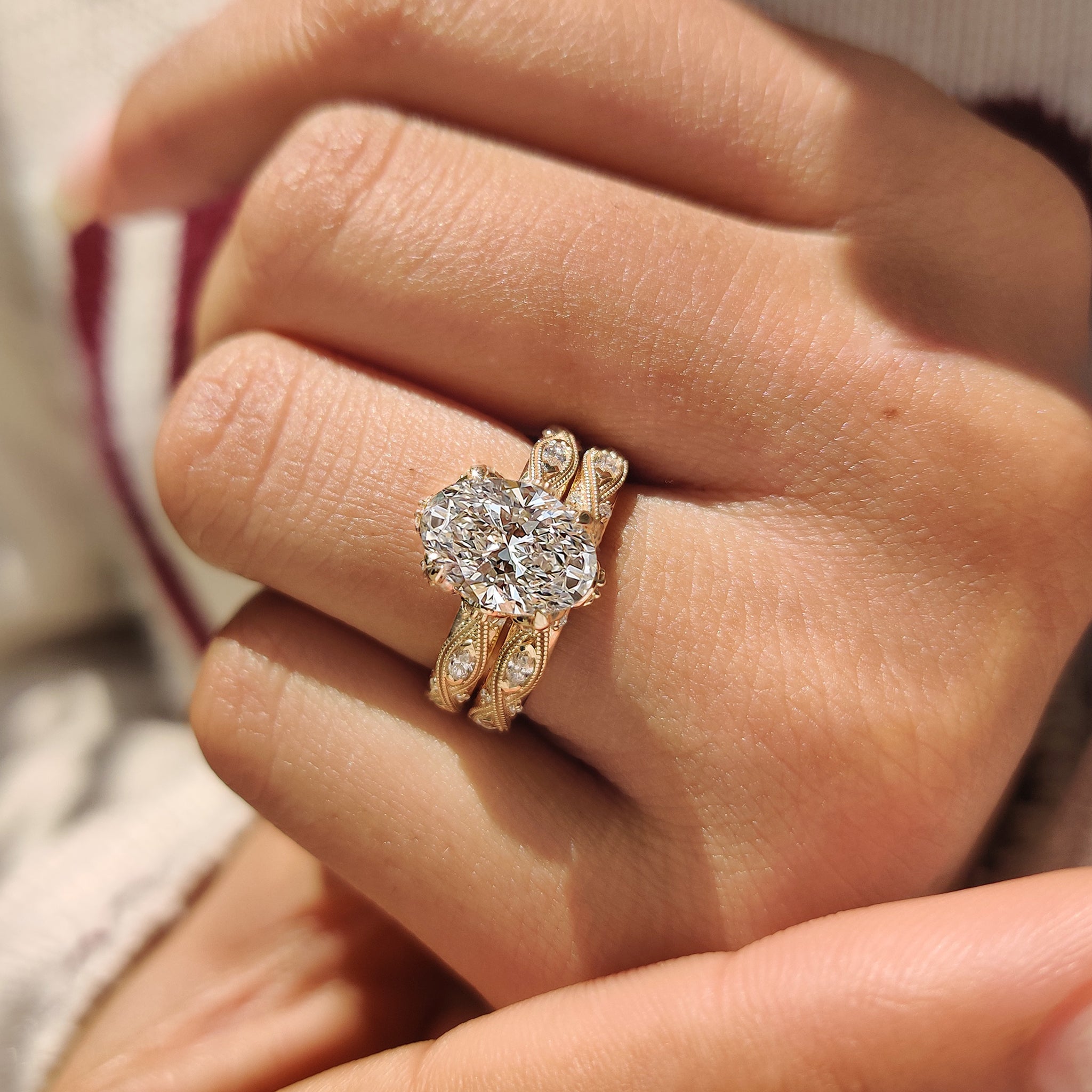 Vintage oval diamond ring with hidden accents and milgrain finish.
