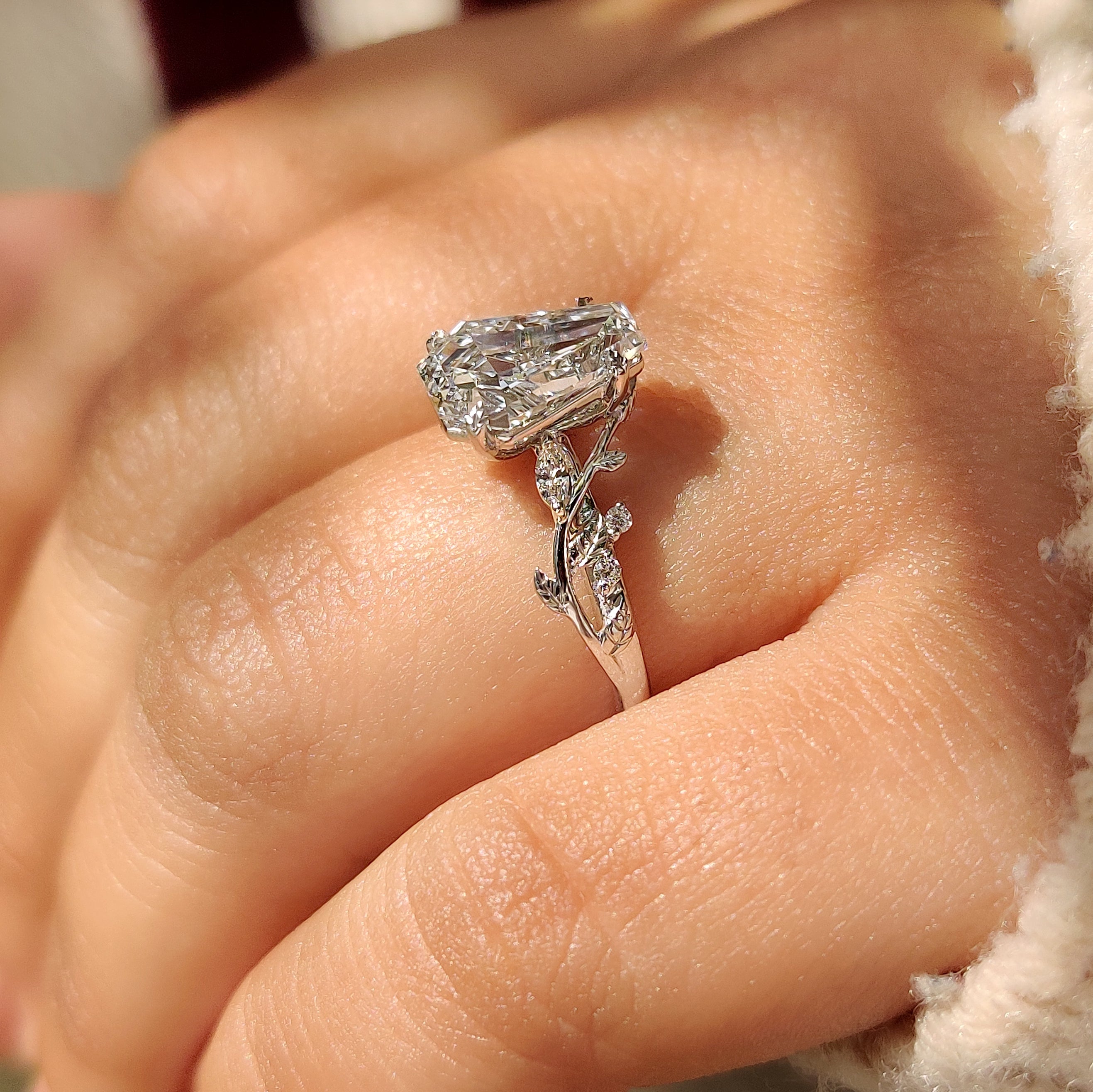 Handmade coffin cut diamond ring with cluster side stones.
