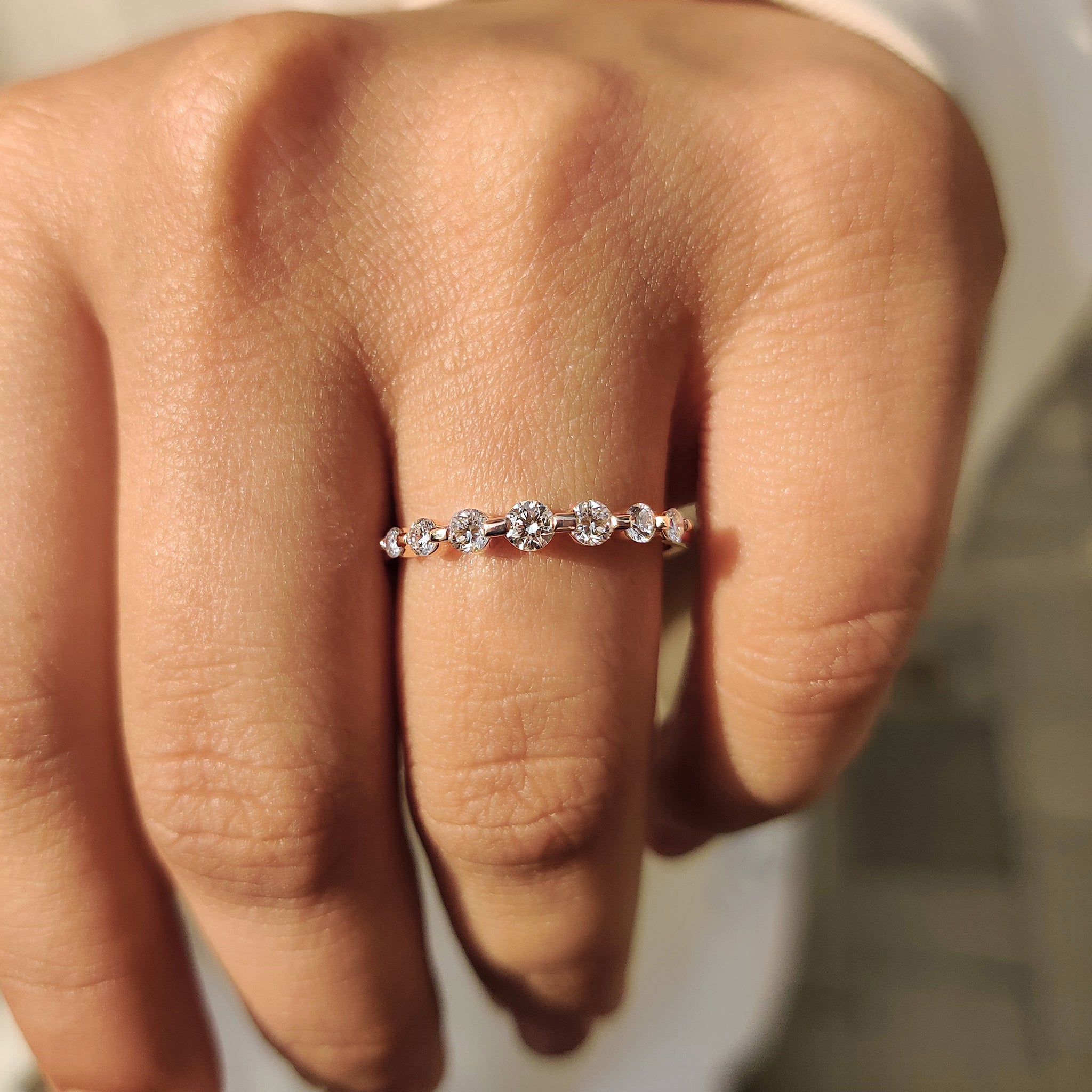 Shared prong round diamond band with seven stone style.
