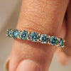 Half eternity moissanite band with blue round stones.
