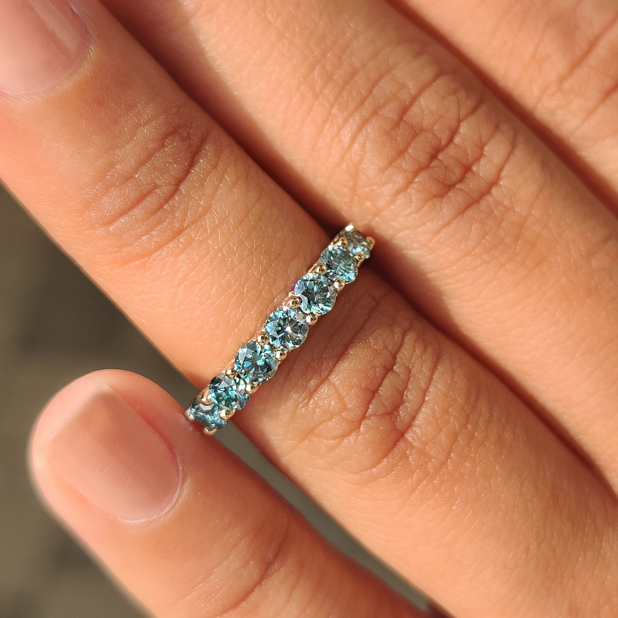 Half eternity blue moissanite band with micro pave.
