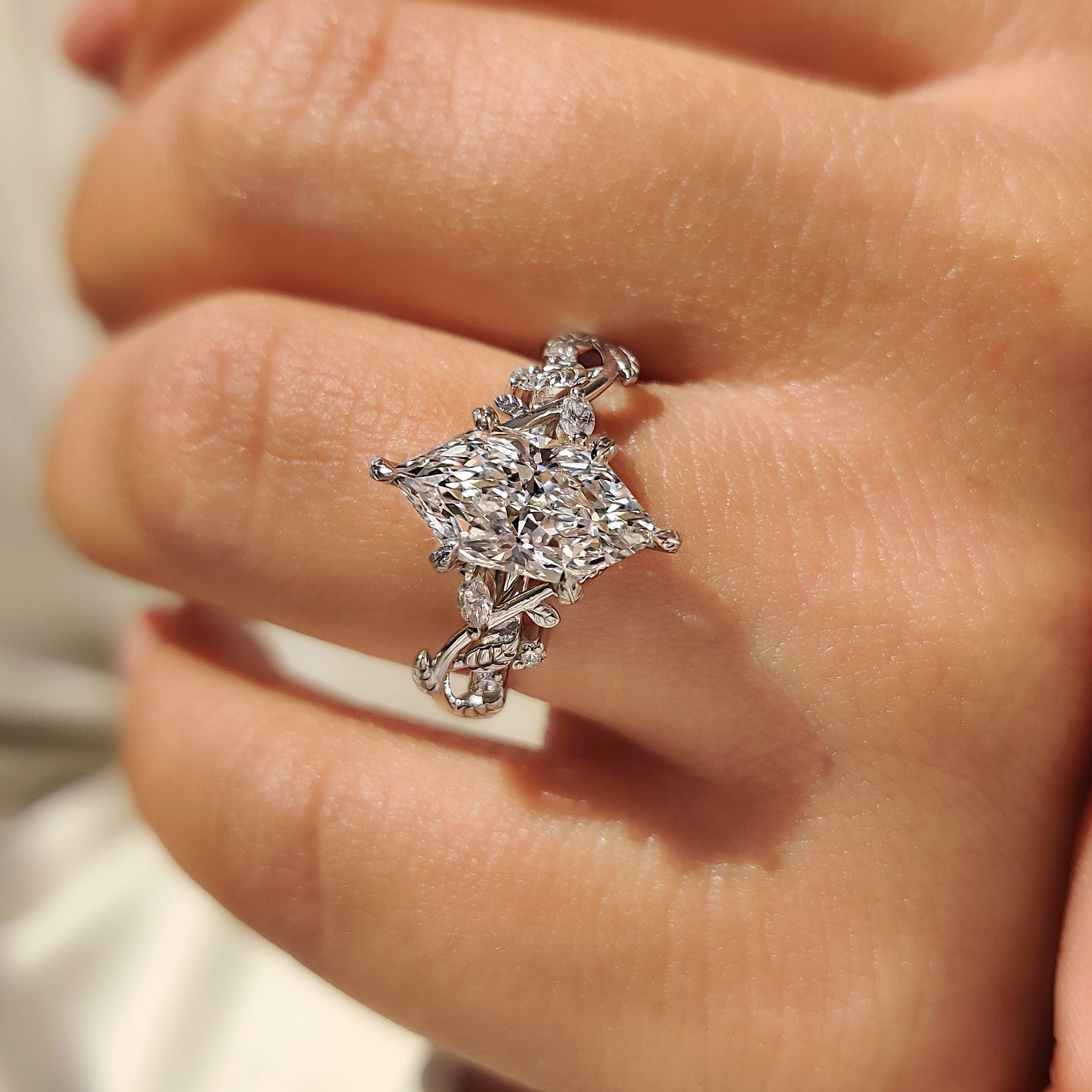 Marquise cut engagement ring with round side diamonds.
