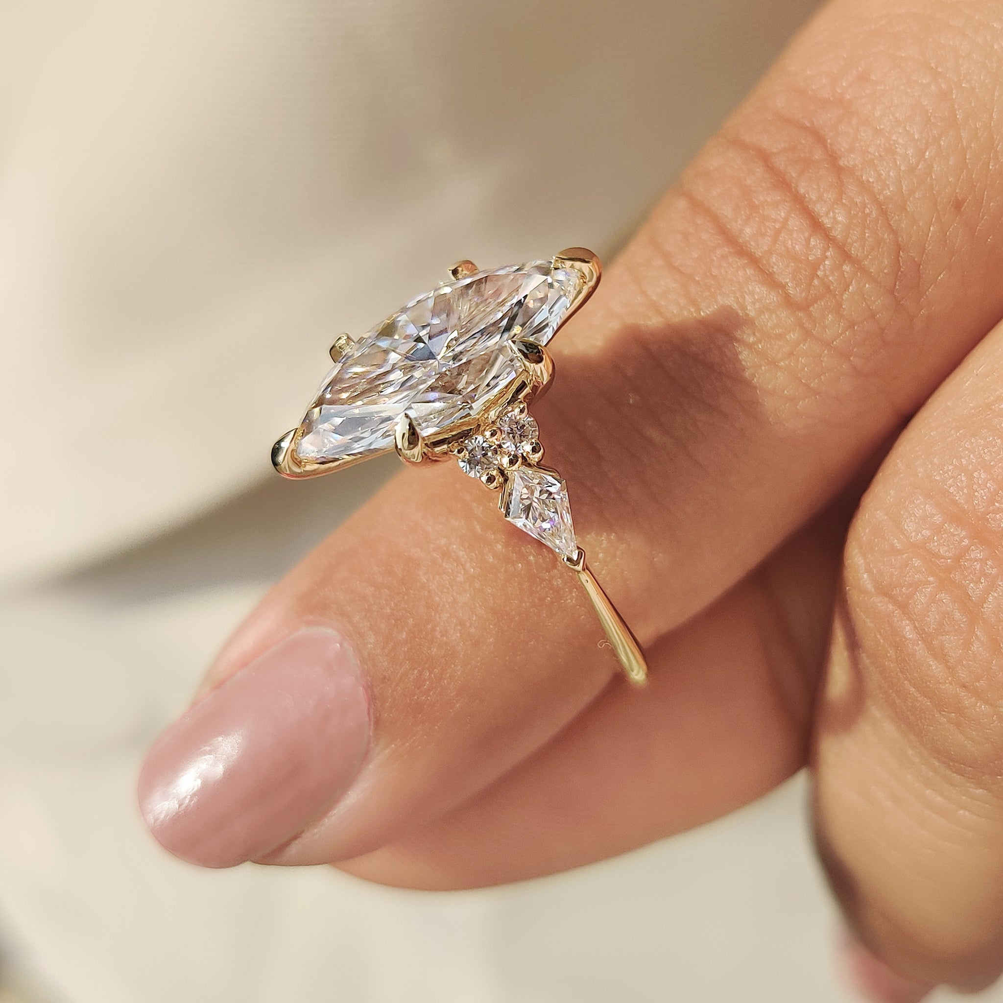 Marquise ring with round side stones design.
