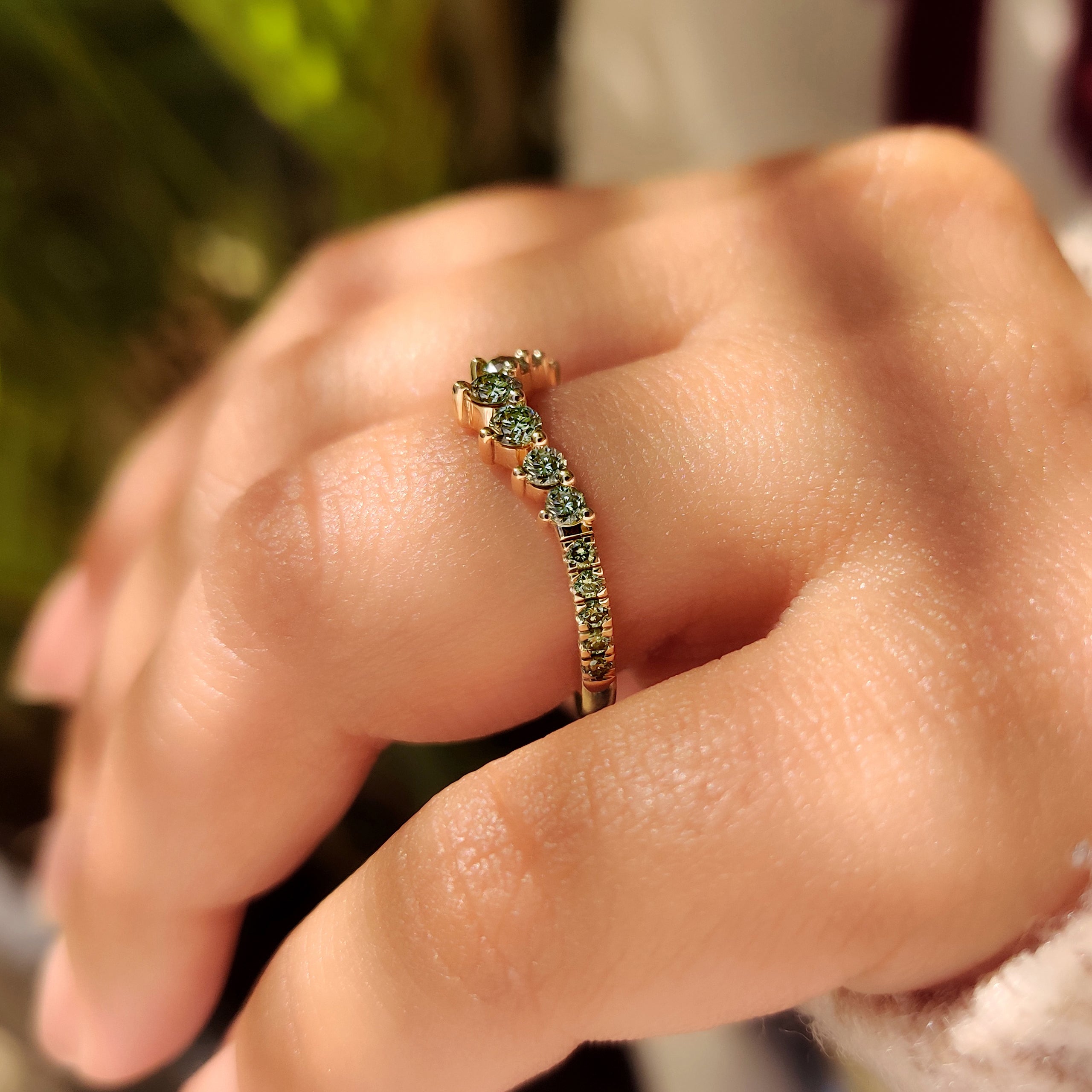 Handmade V shape band with green round diamond accents
