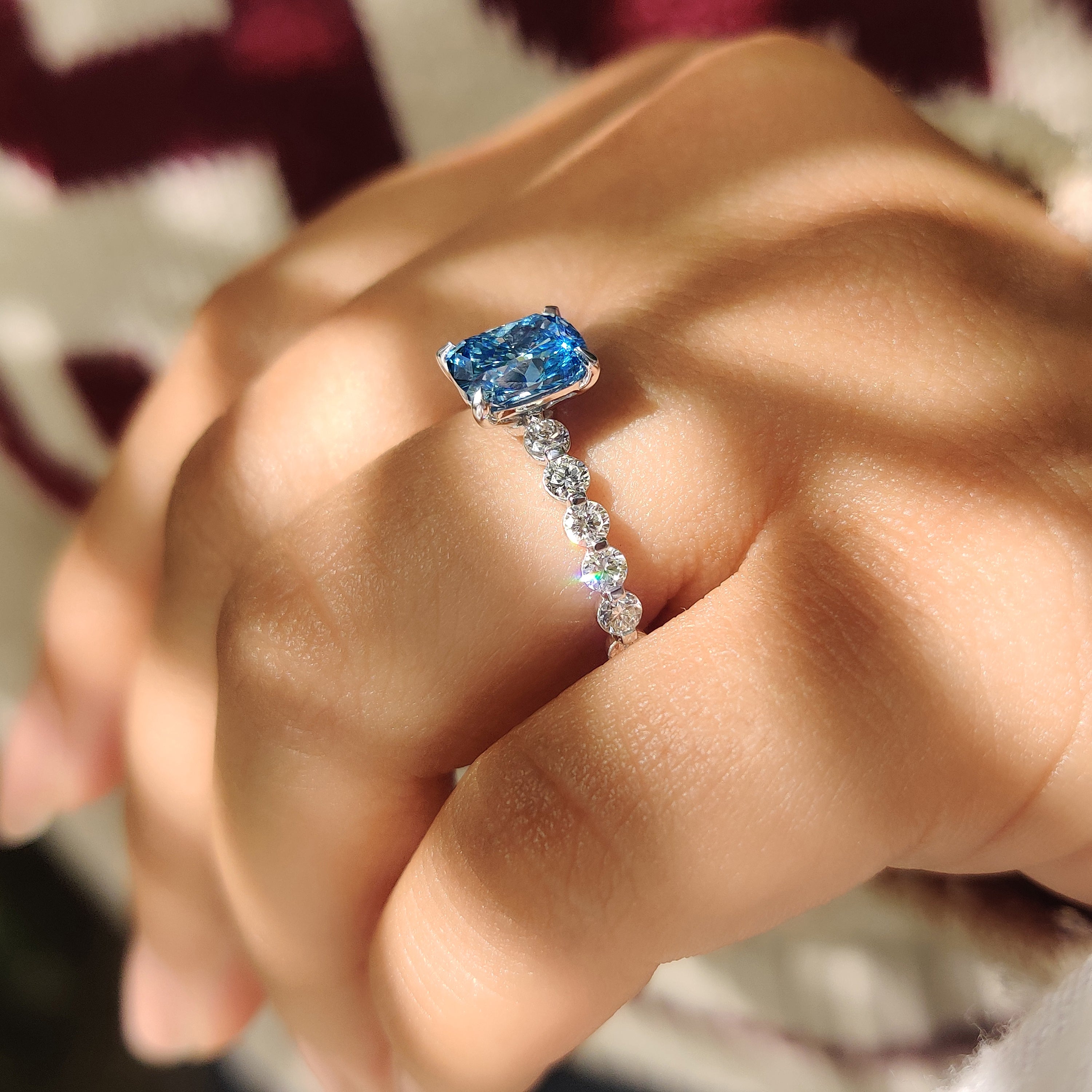 Cushion diamond ring with round diamond pave.
