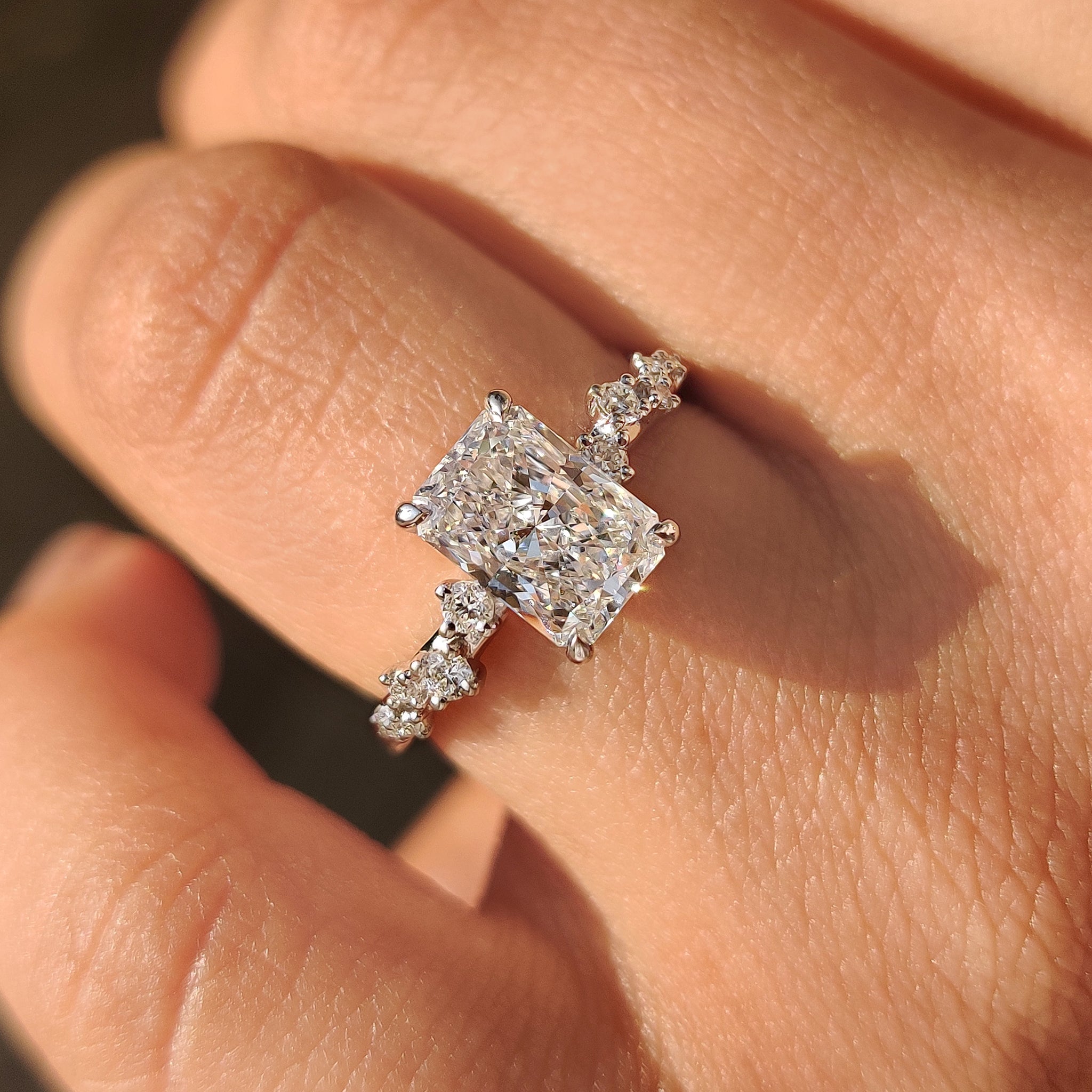 Handmade radiant cut ring with refined cluster setting style.
