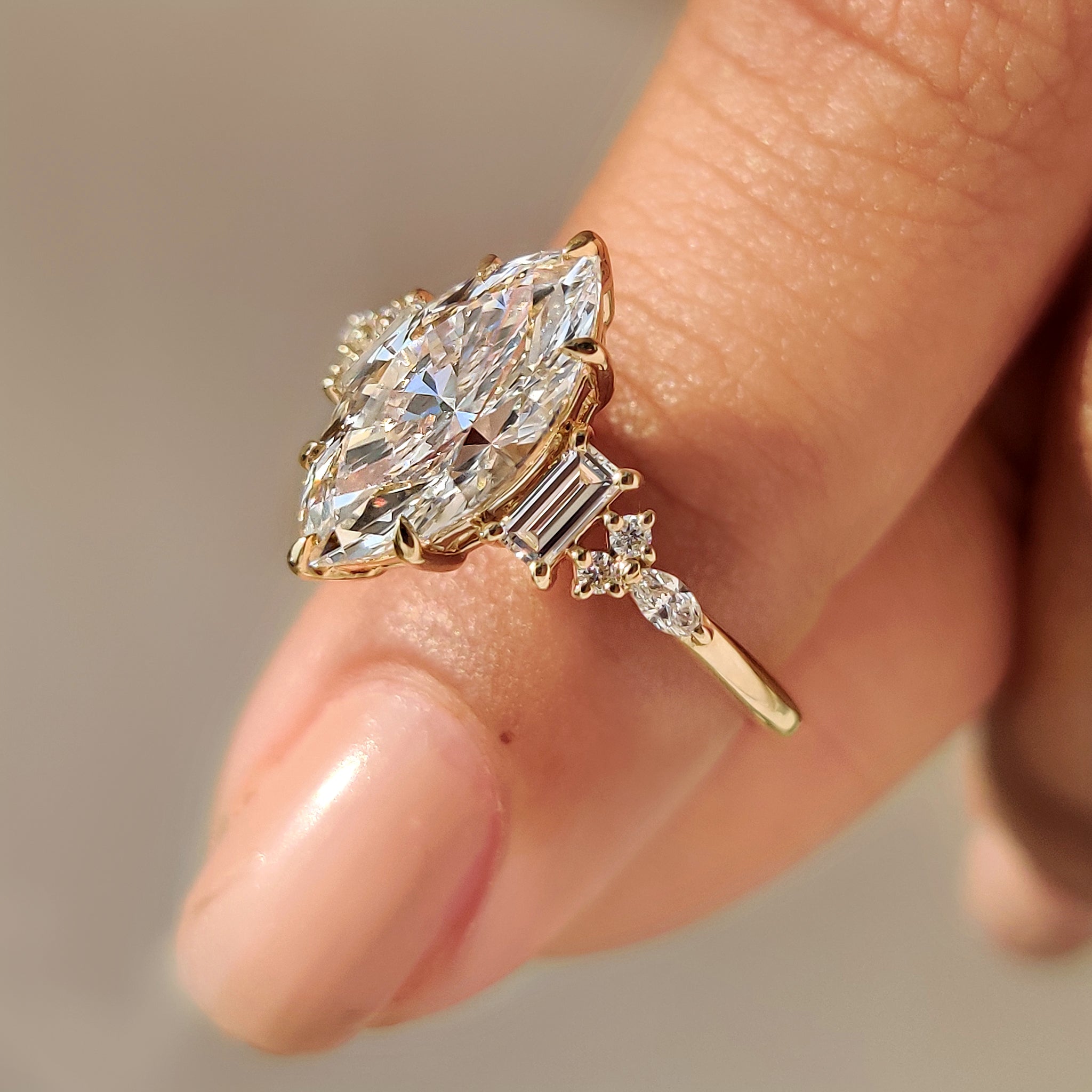 Muse setting marquise diamond ring with side stones.
