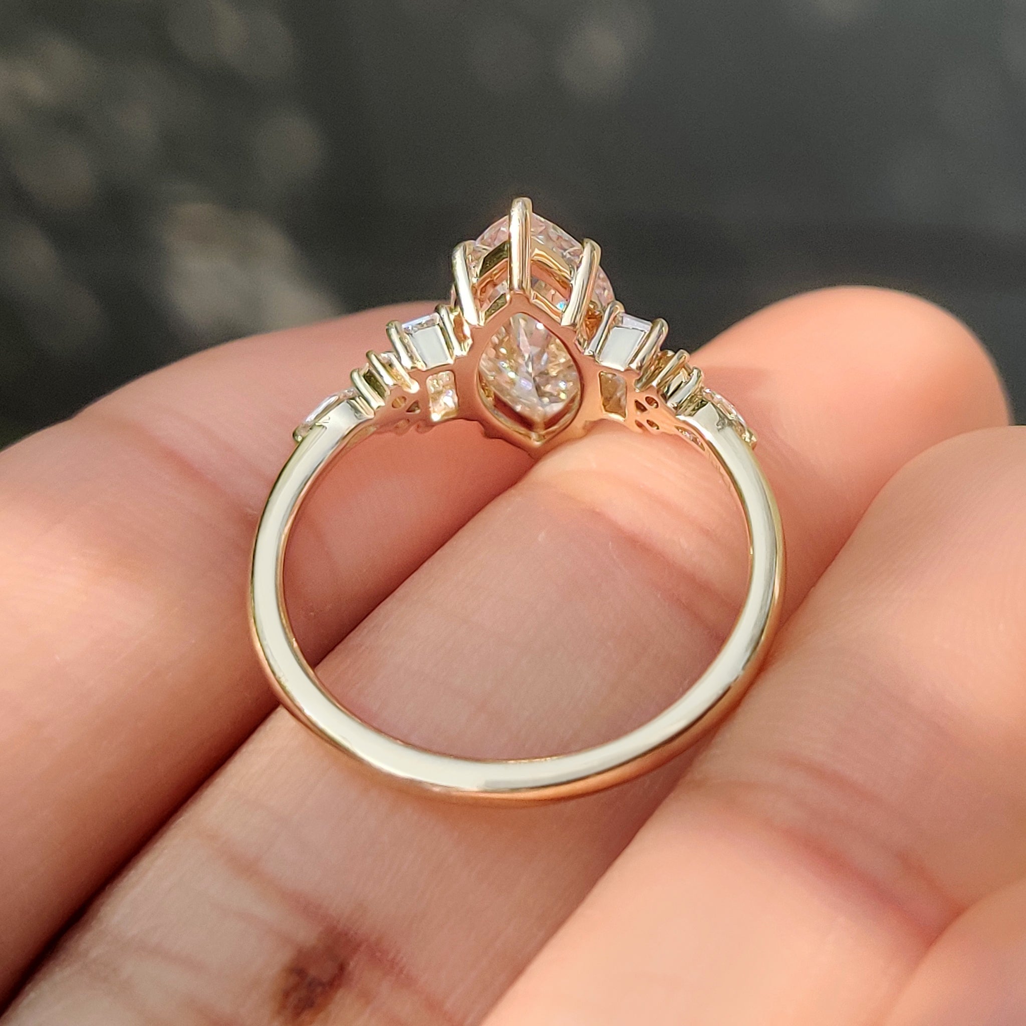 Marquise cut diamond ring with round side stones.
