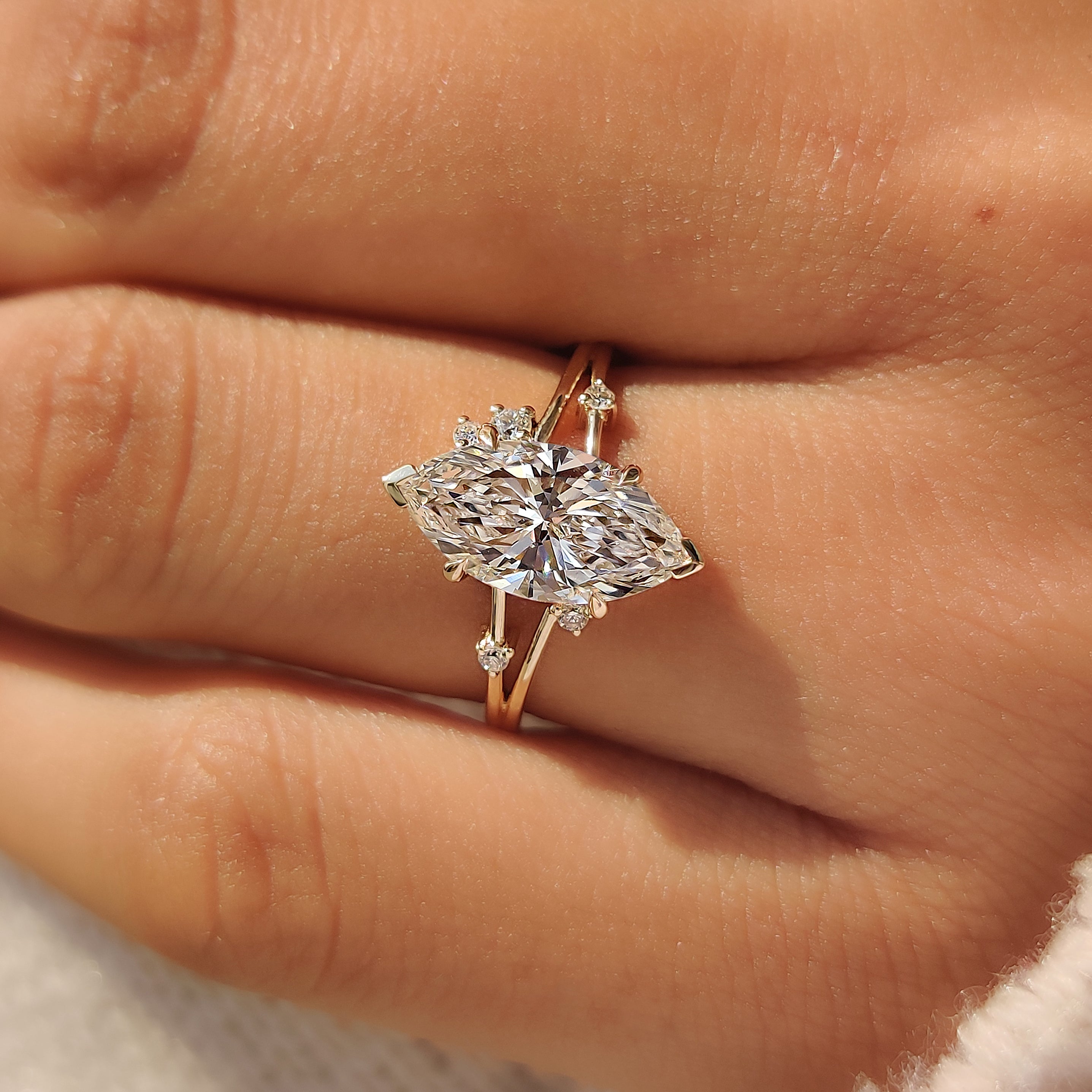 V-shaped prongs securing the pointed ends of a marquise diamond.

