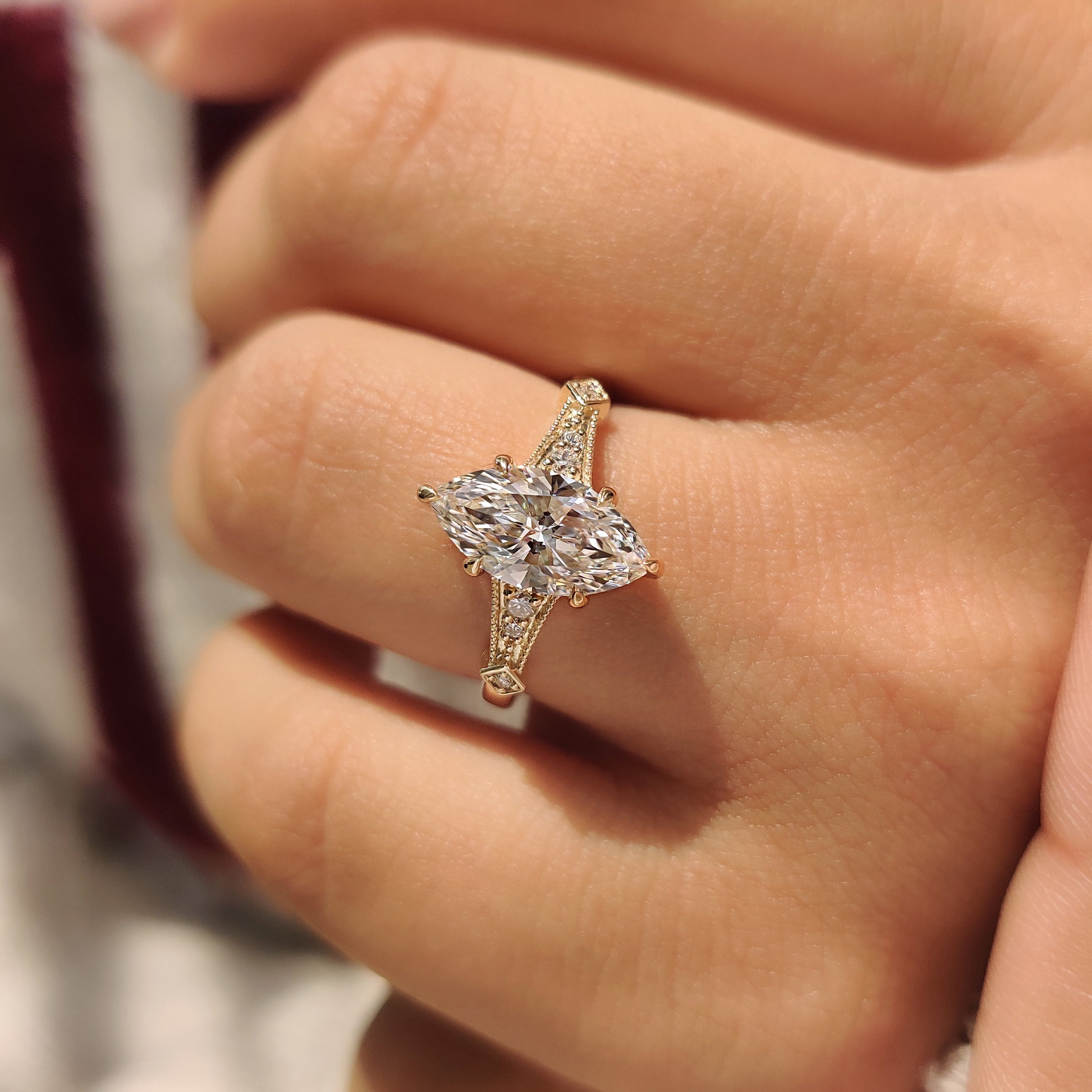 Handmade marquise lab diamond ring with round side stones.
