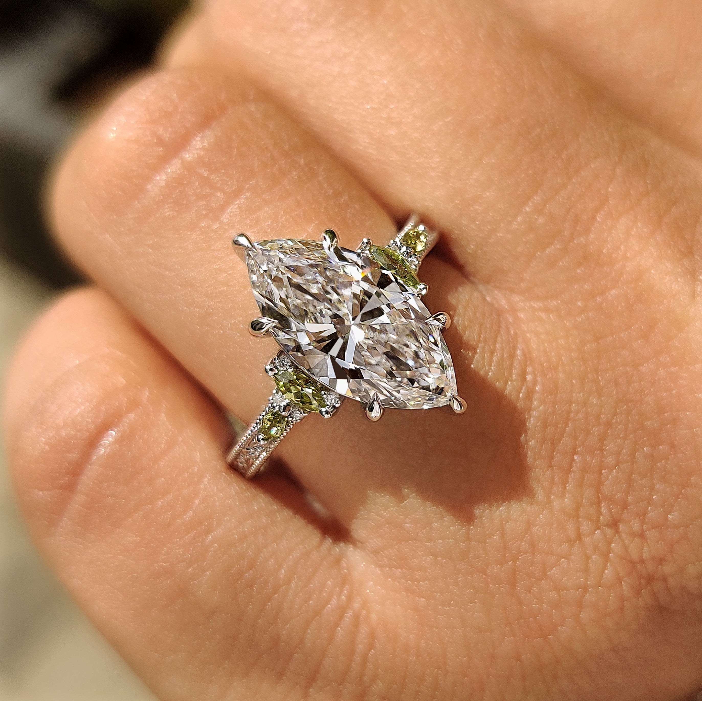 Lab grown marquise diamond ring with peridot side accents
