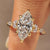 Marquise diamond ring with marquise side stone and muse setting
