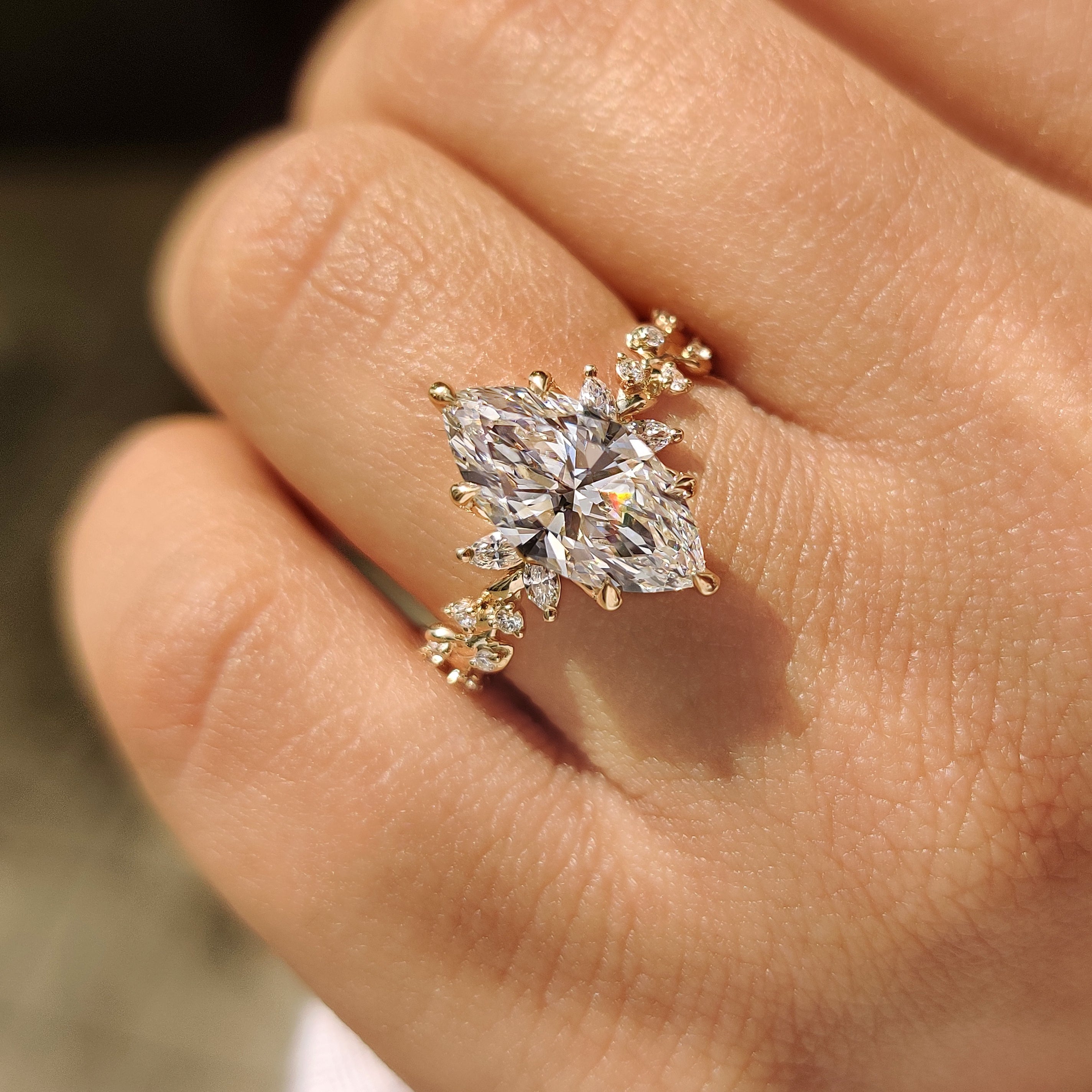 Twisted shank marquise diamond ring with tulip setting.
