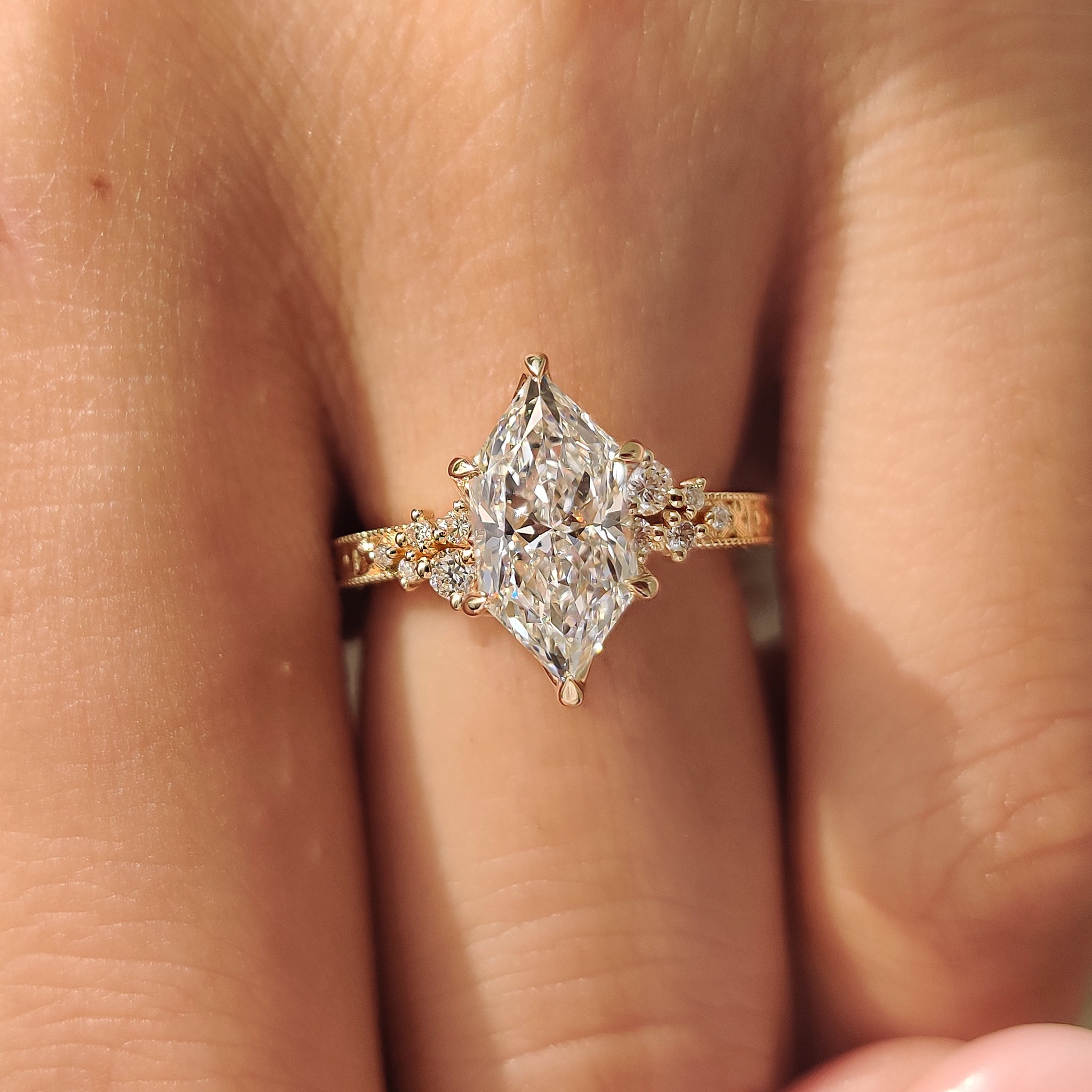 Floral engraved shank ring with round side stones.
