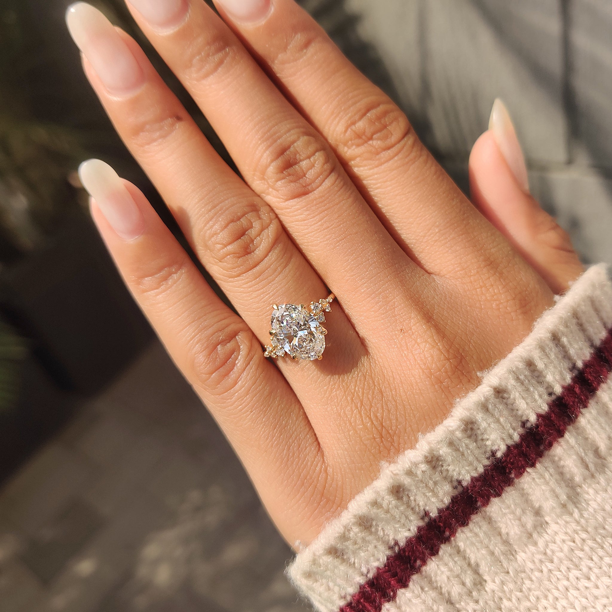 Lab grown oval diamond ring with round side accents.
