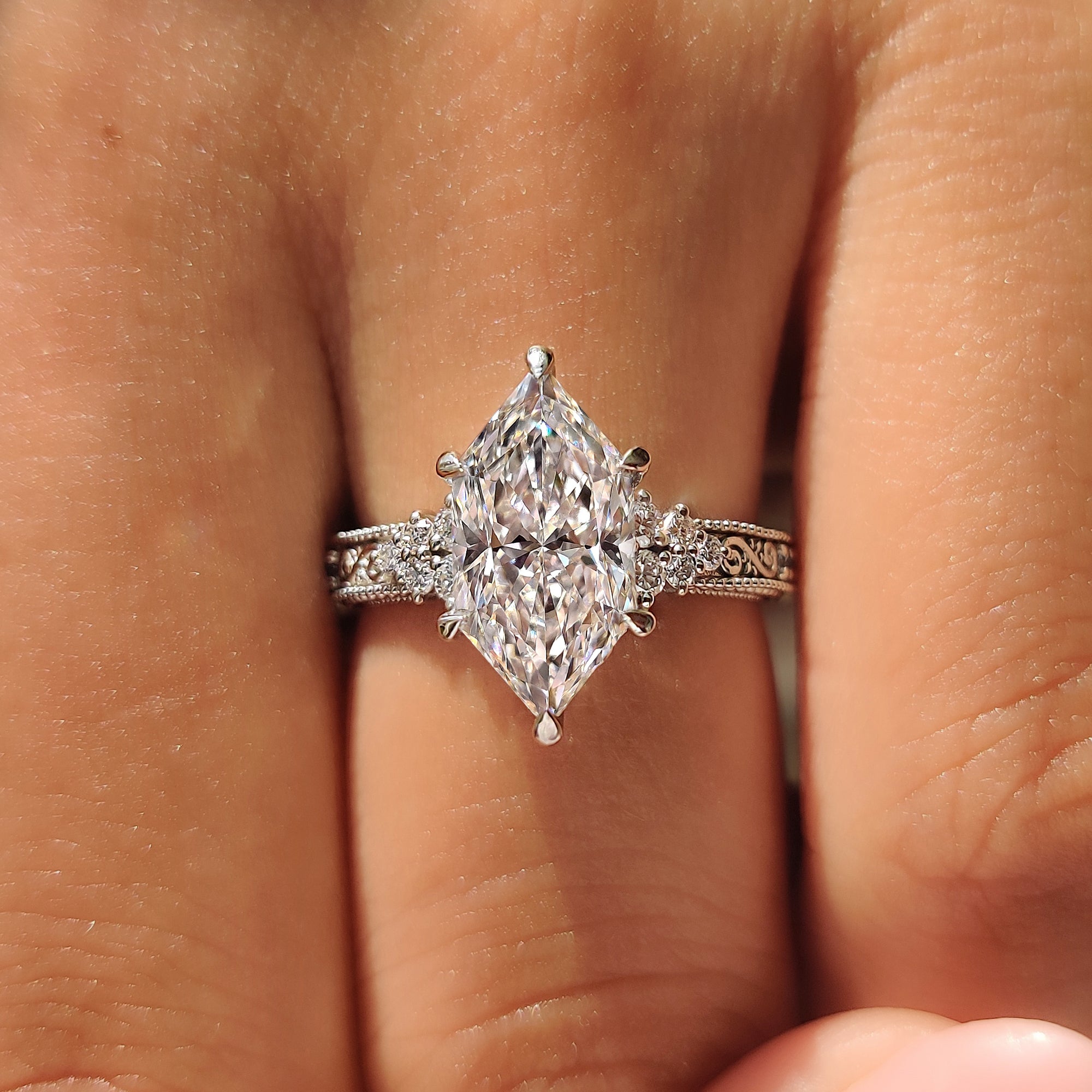 Round aquamarine birthstones on a Dutch marquise engagement ring.
