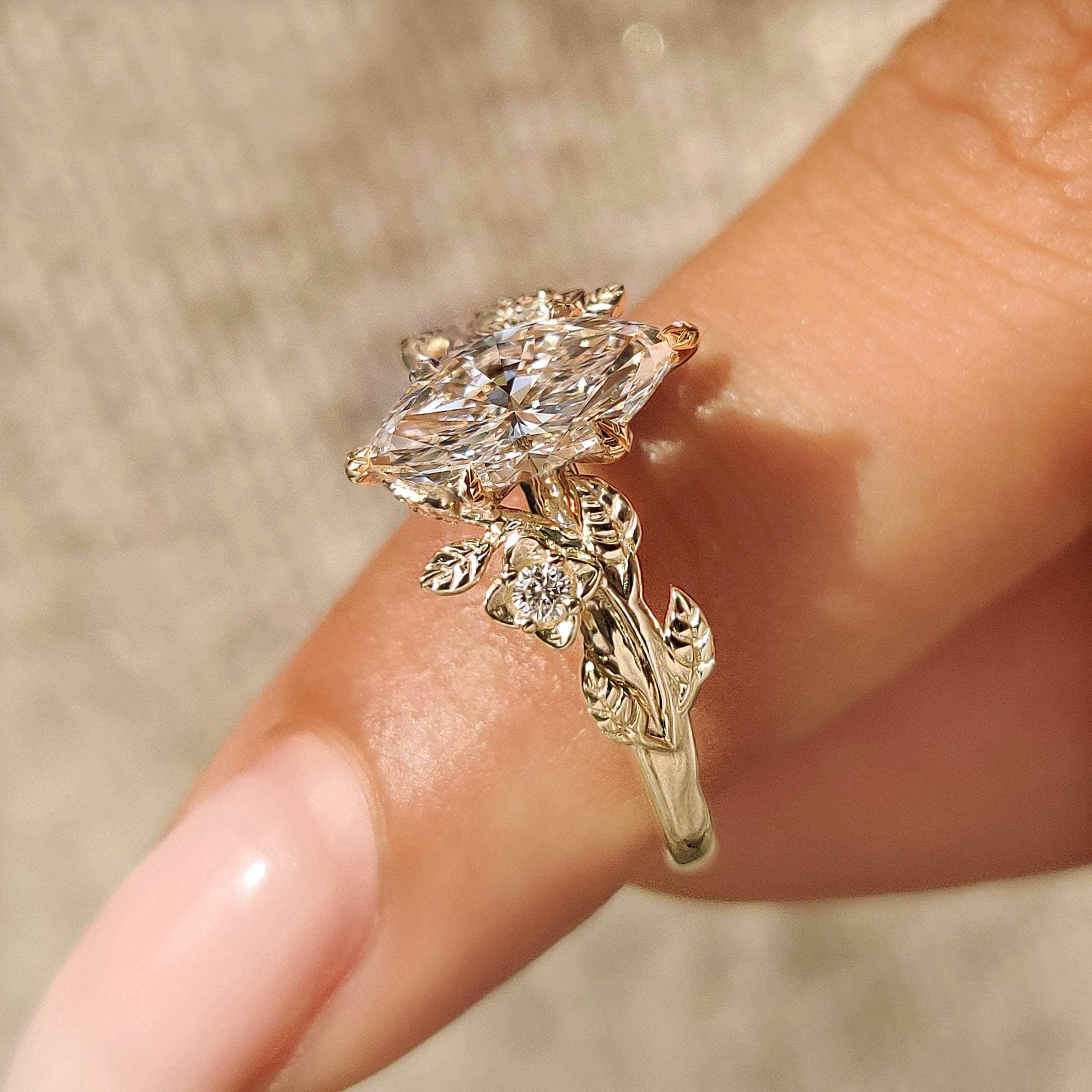 Nature inspired marquise ring with round diamond side accents
